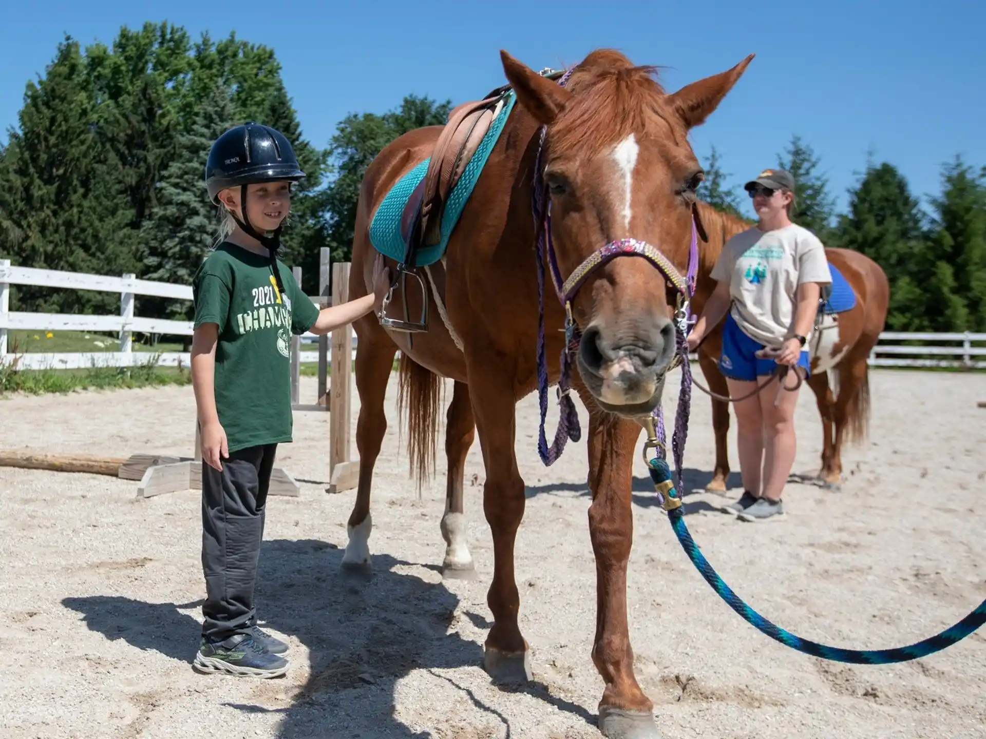 a couple of men standing next to a horse