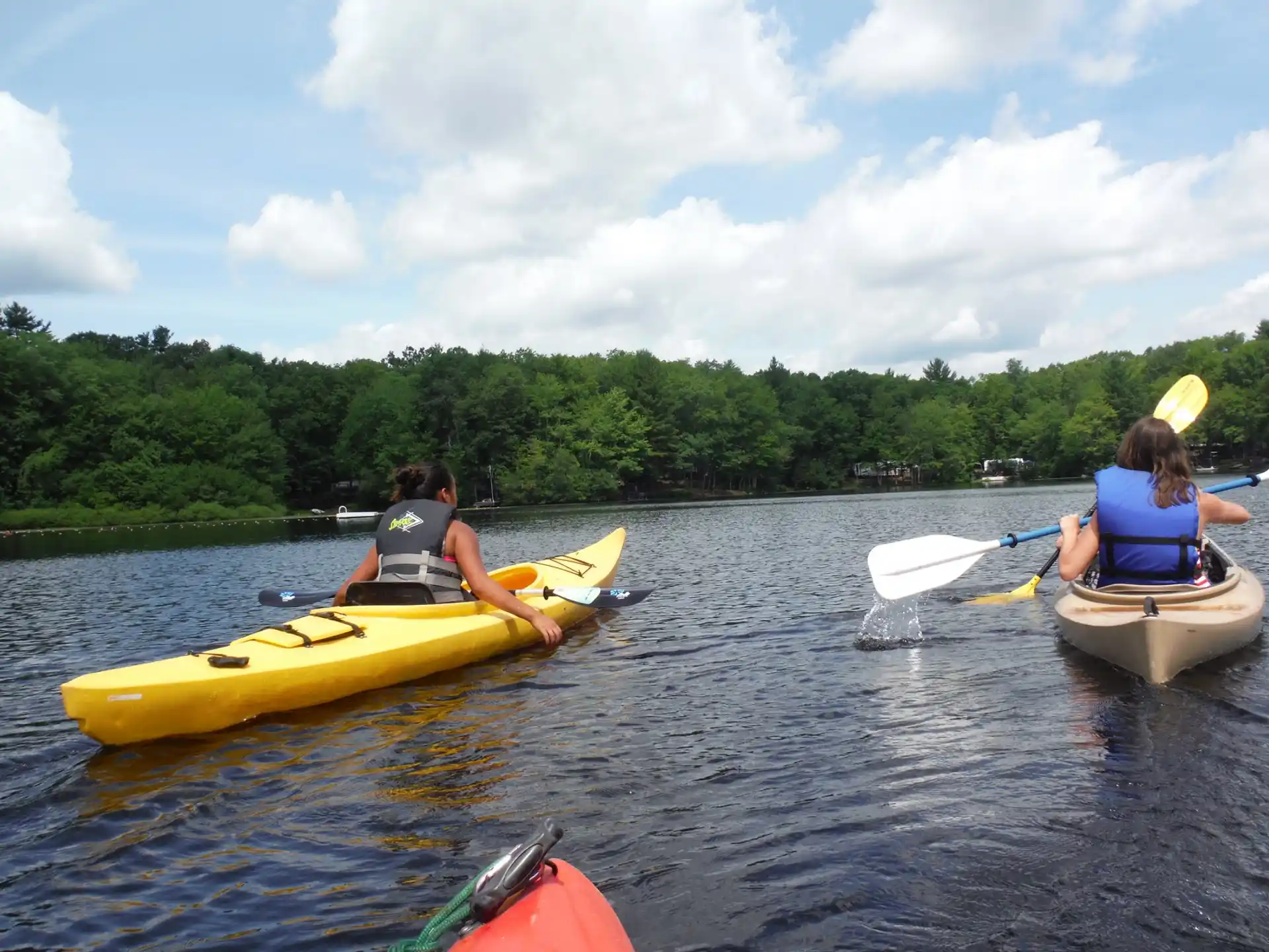 a couple of people in kayaks on a river