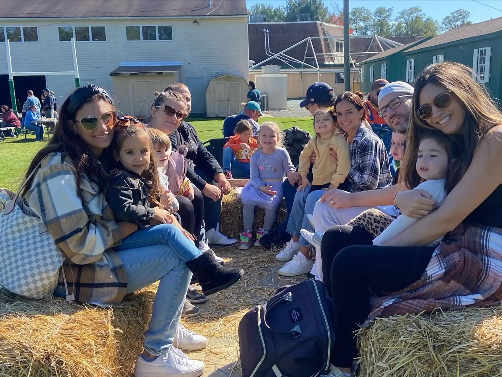 a group of people sitting on hay