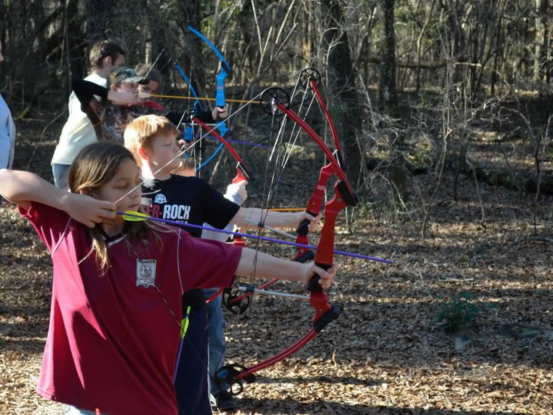 a group of people shooting bows