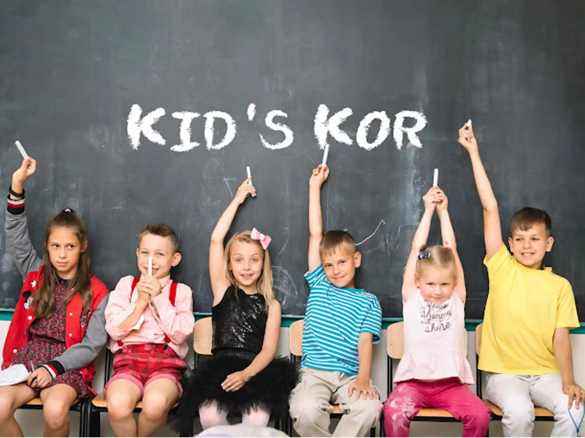 a group of children sitting on a blackboard
