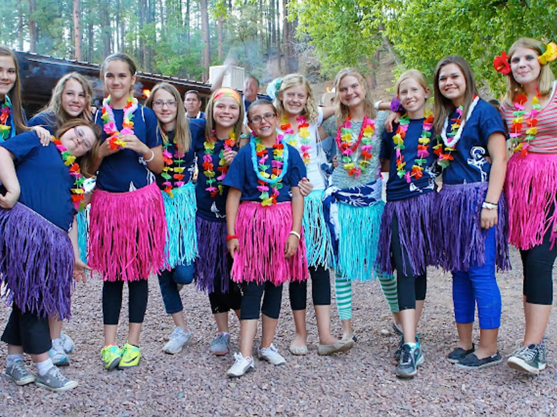 a group of girls in colorful dresses