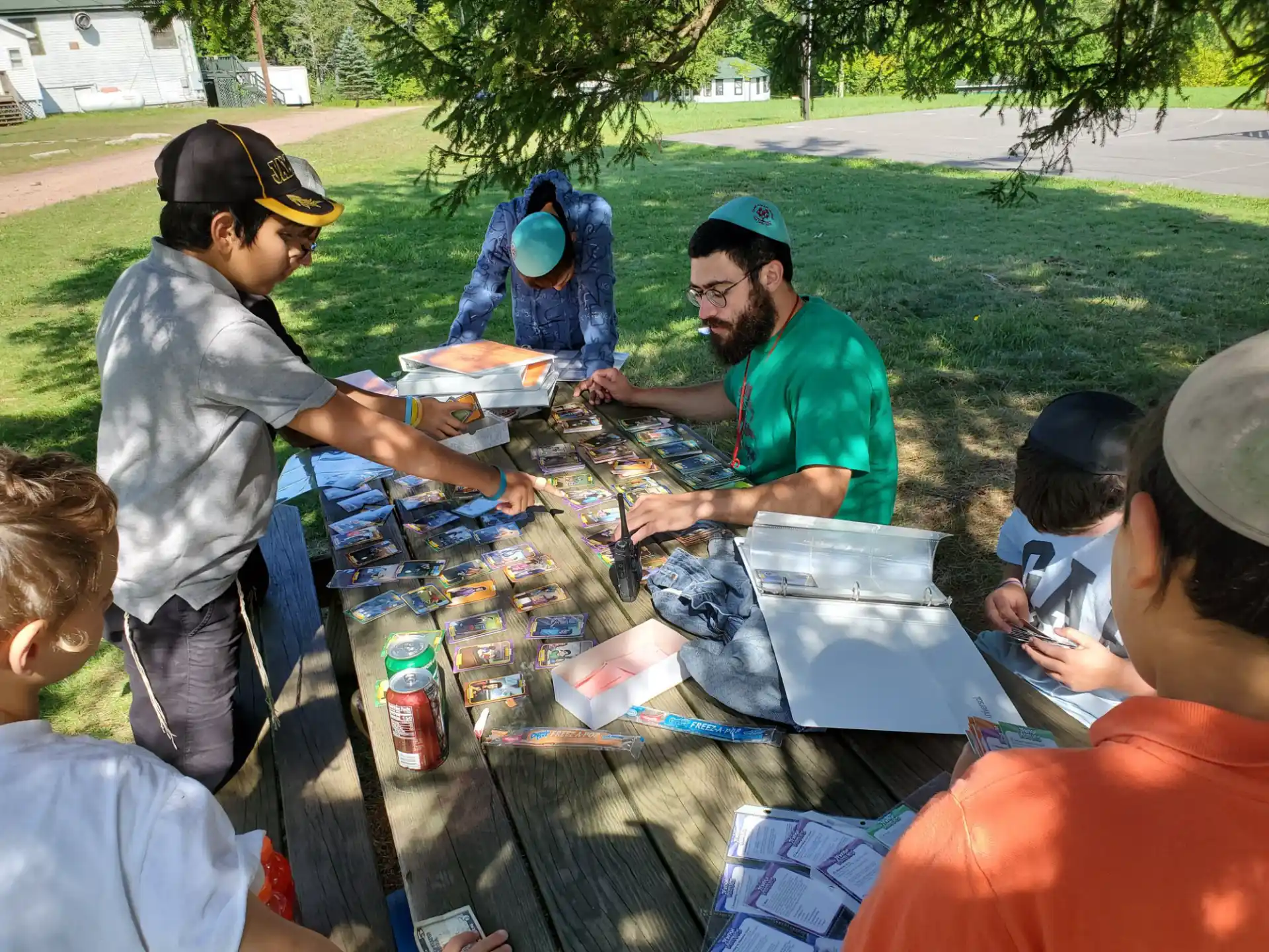 a group of people sitting around a table outside