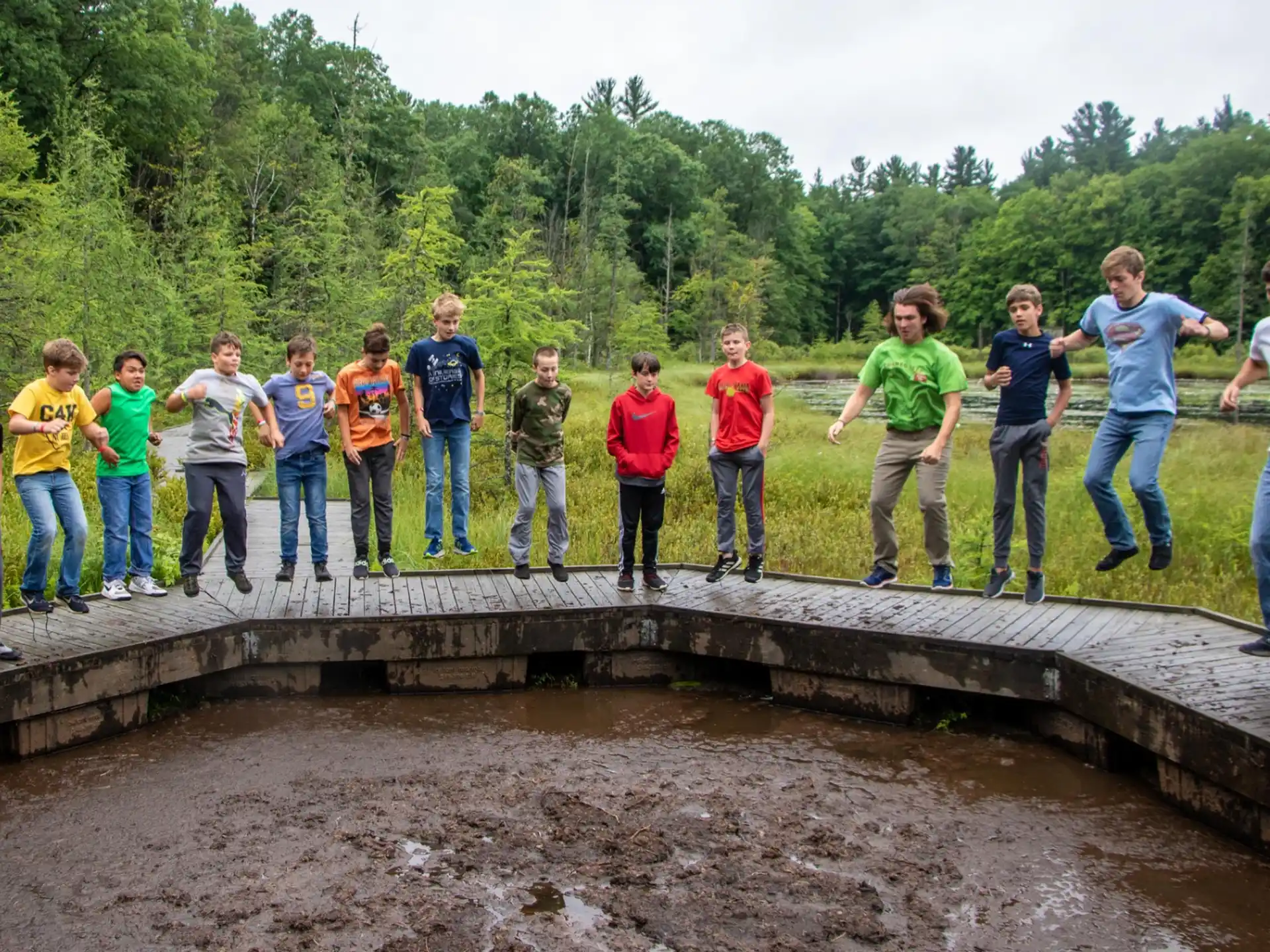 a group of people standing on a dirt path