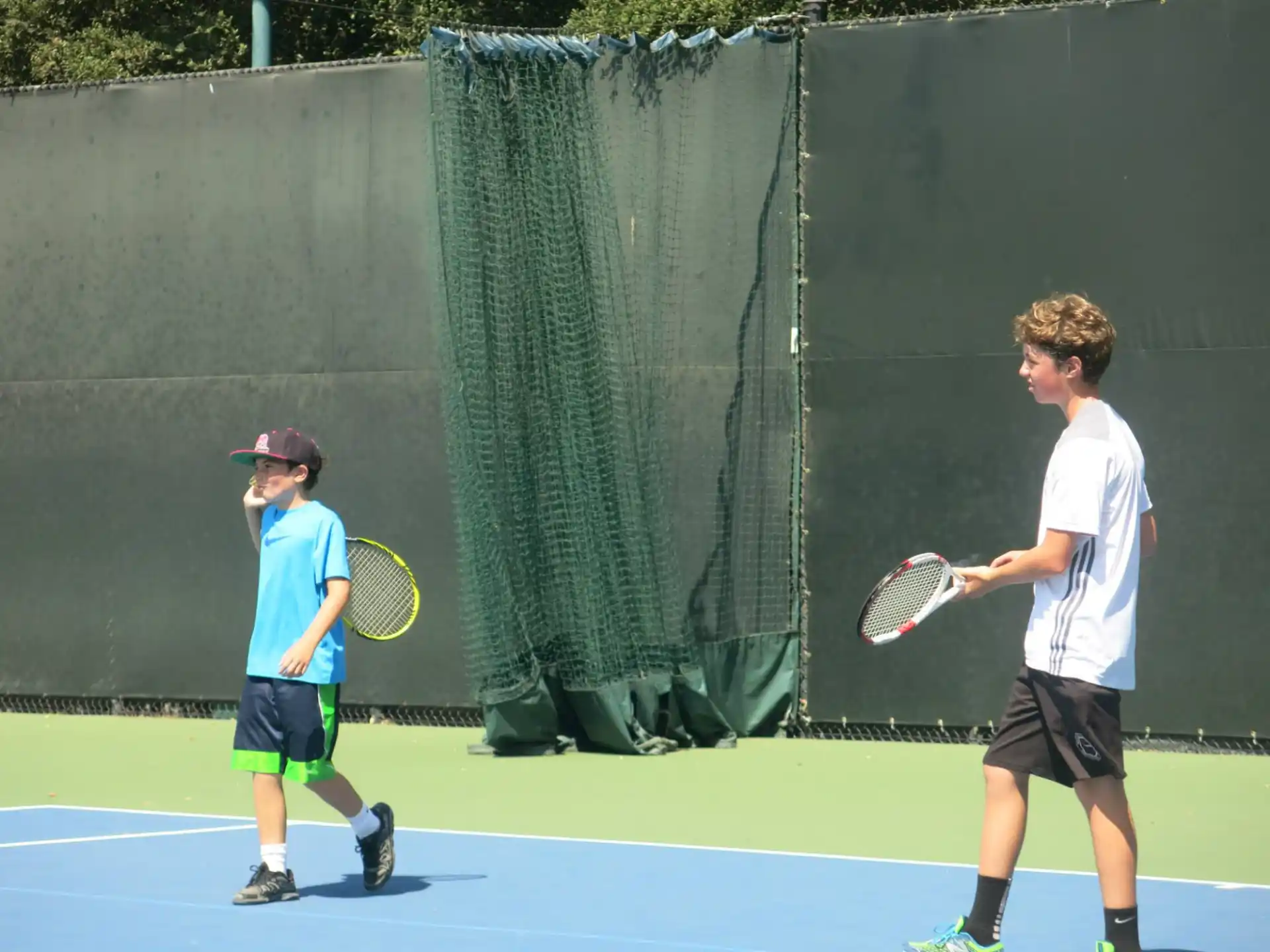 a couple of boys playing tennis