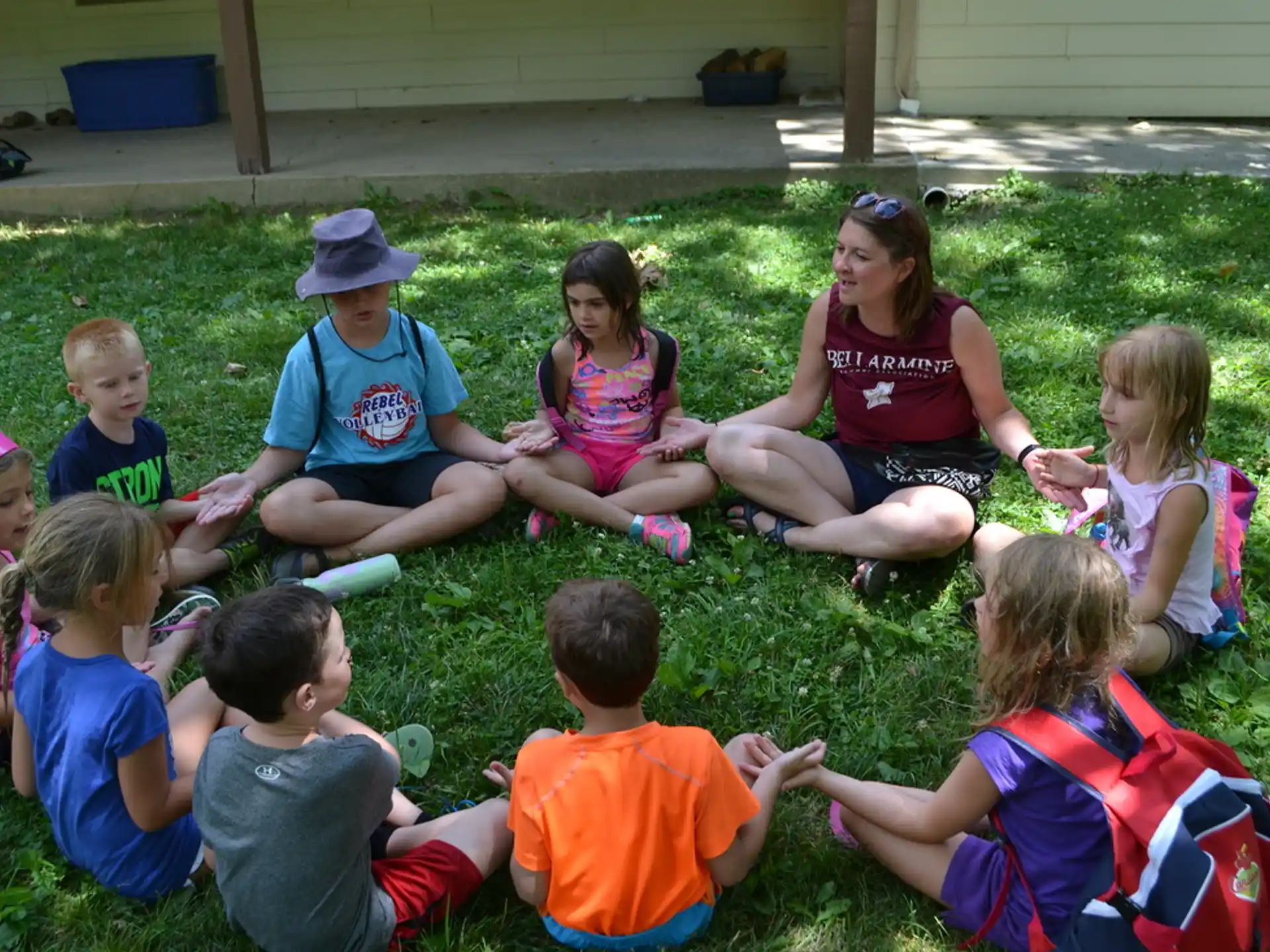 a group of children sitting on the grass