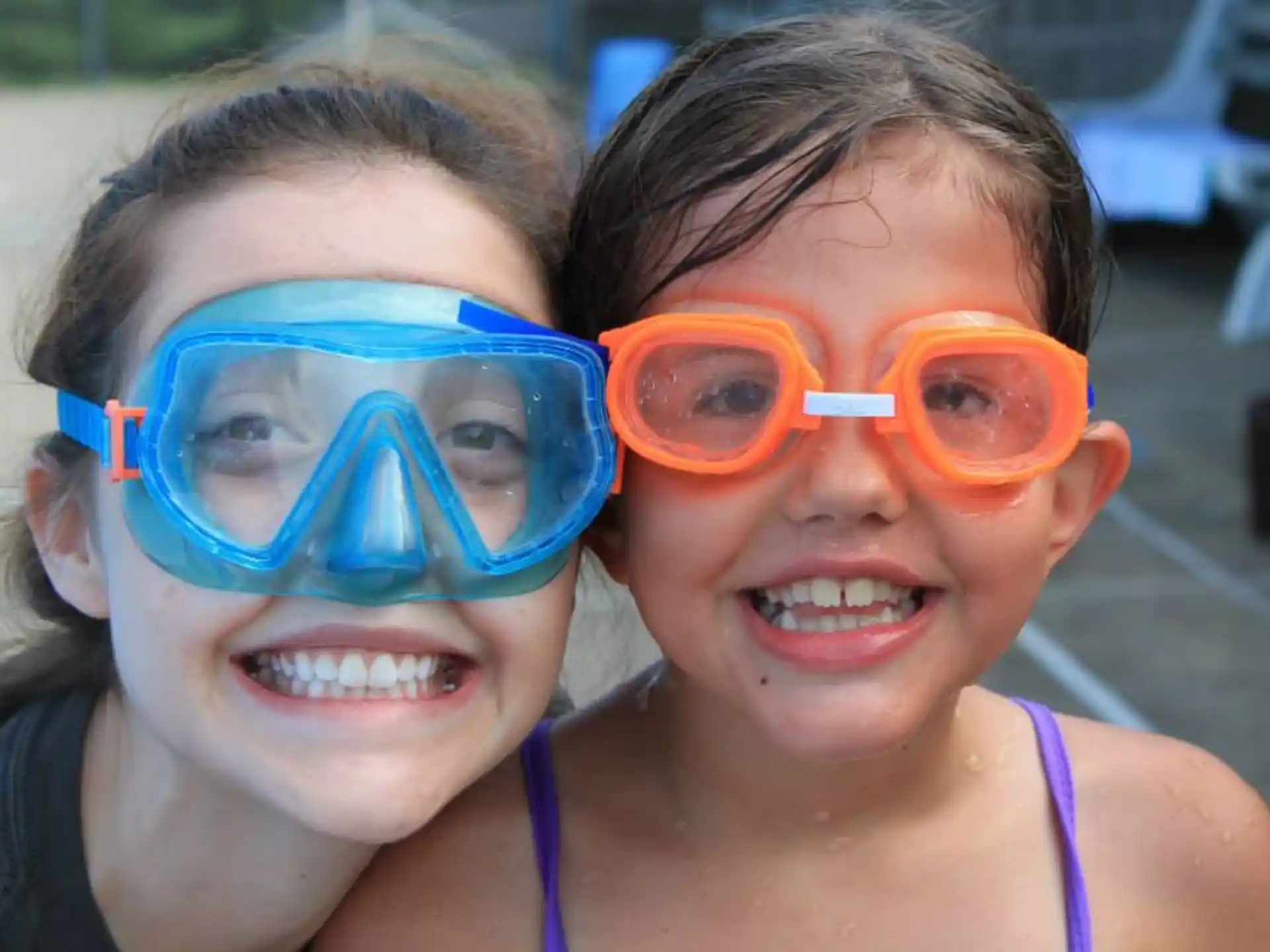 a couple of girls wearing goggles