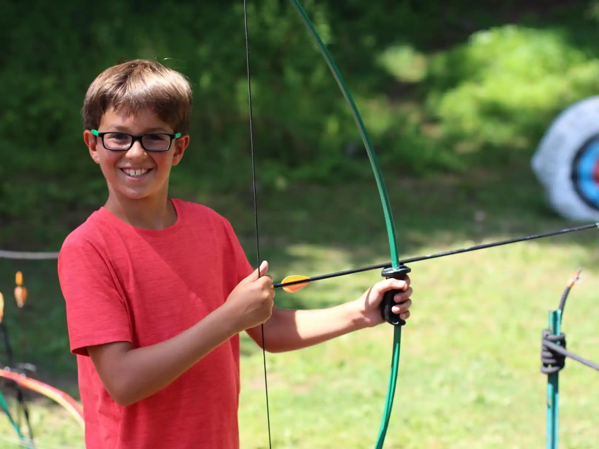 a boy holding a bow and arrow
