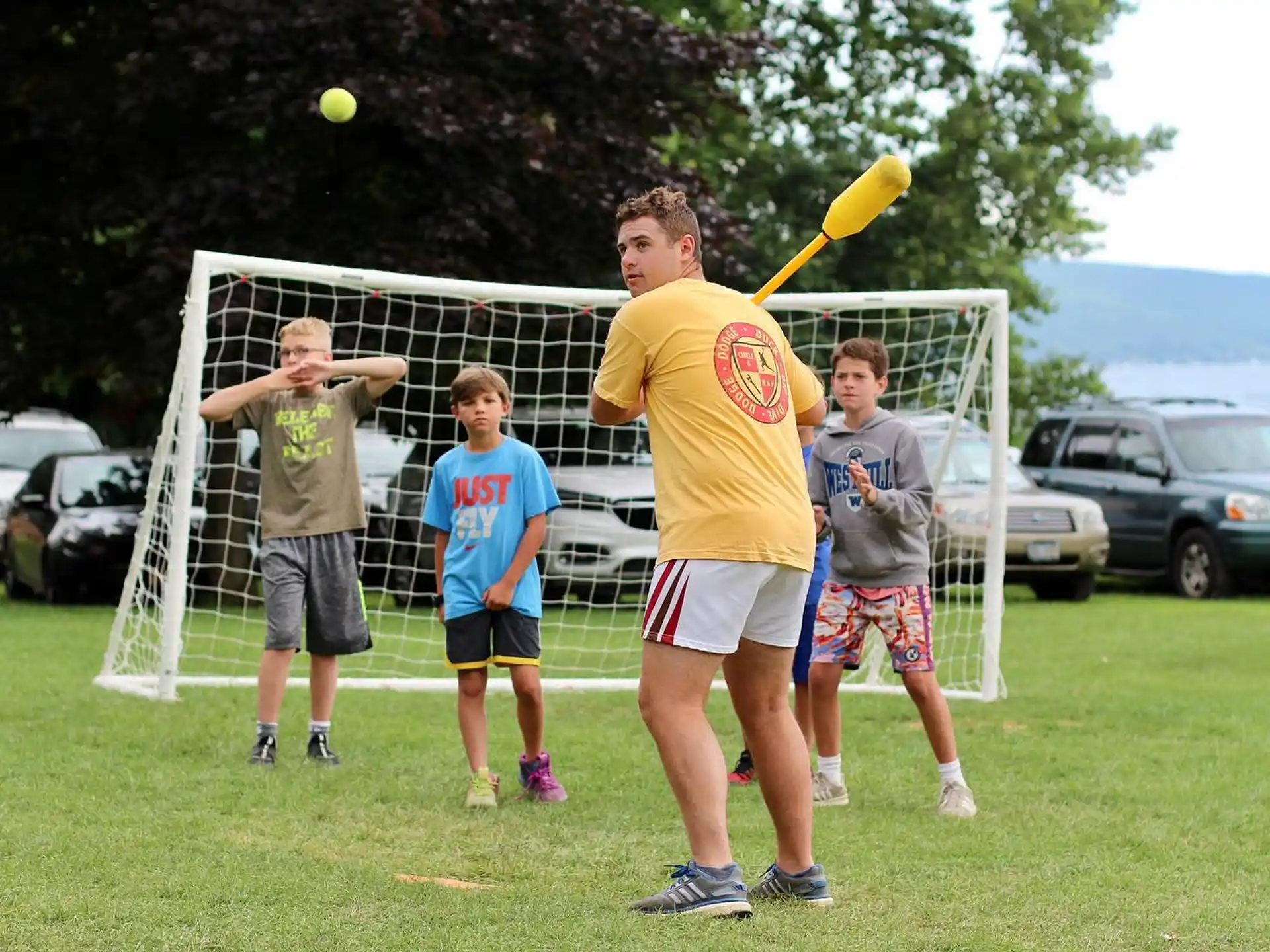 a group of people play baseball