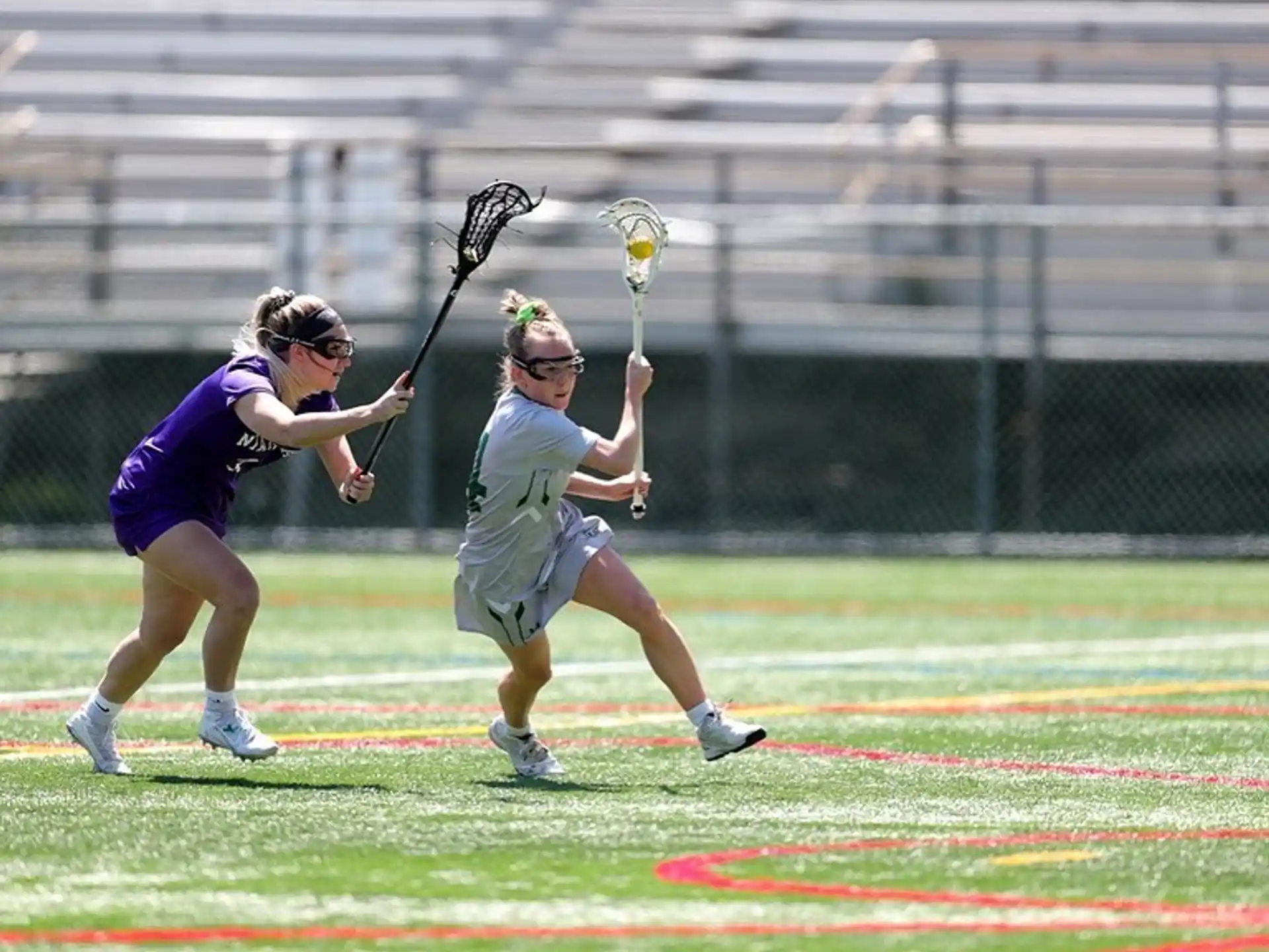 a man and a woman playing lacrosse