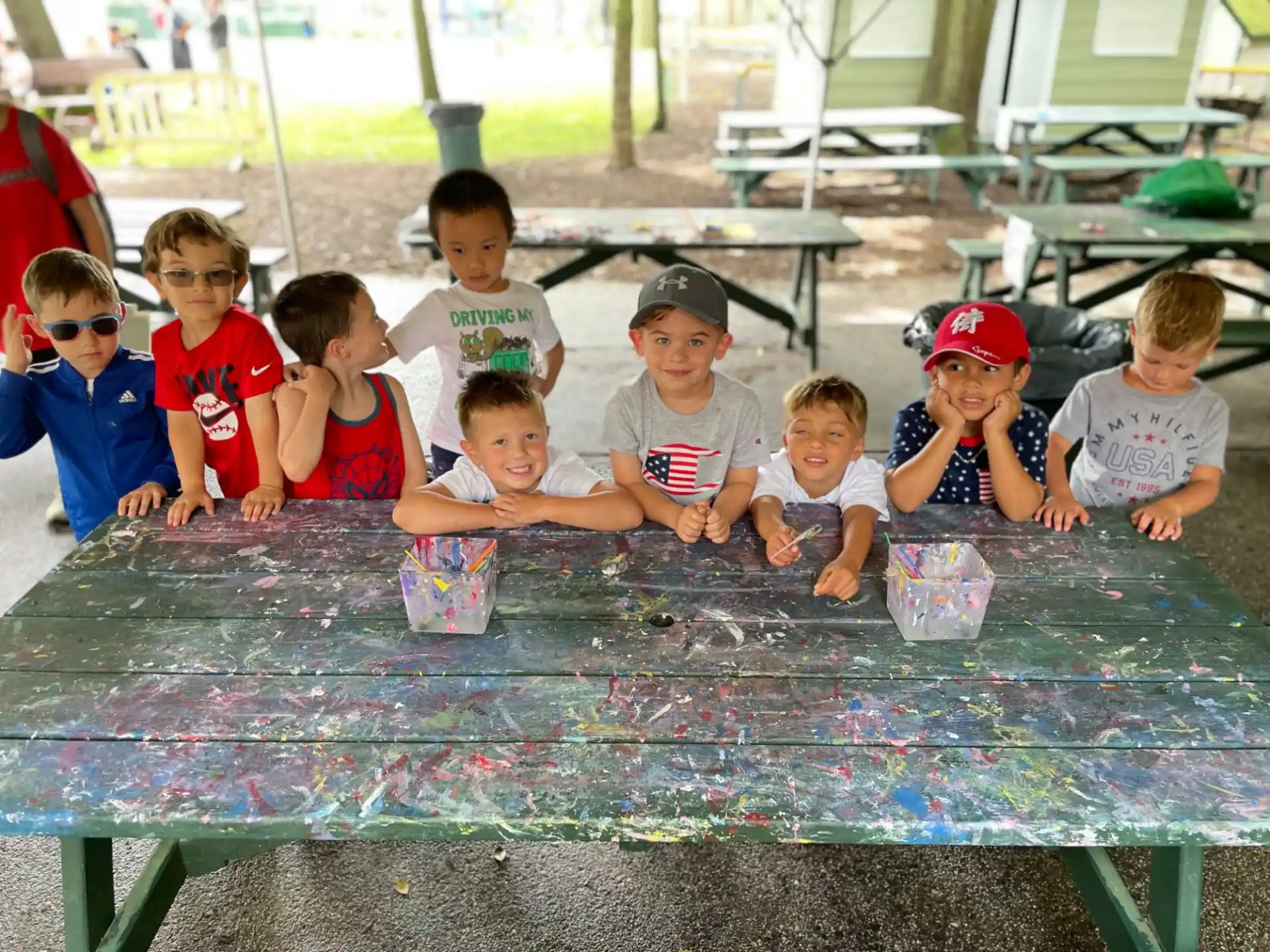 a group of children sitting around a pool