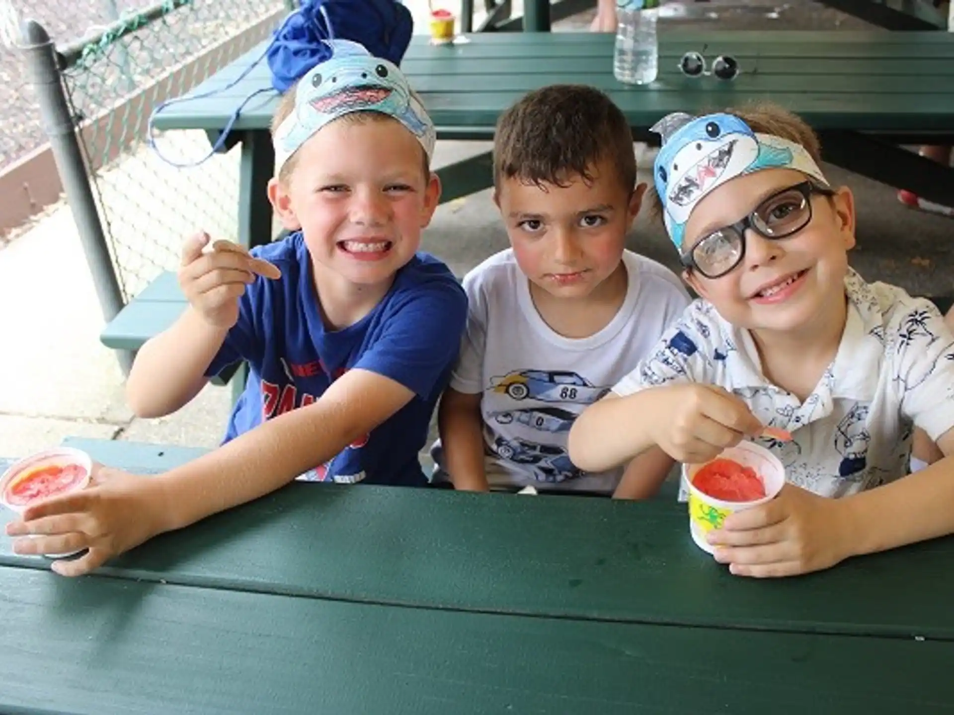 a group of kids sitting at a table