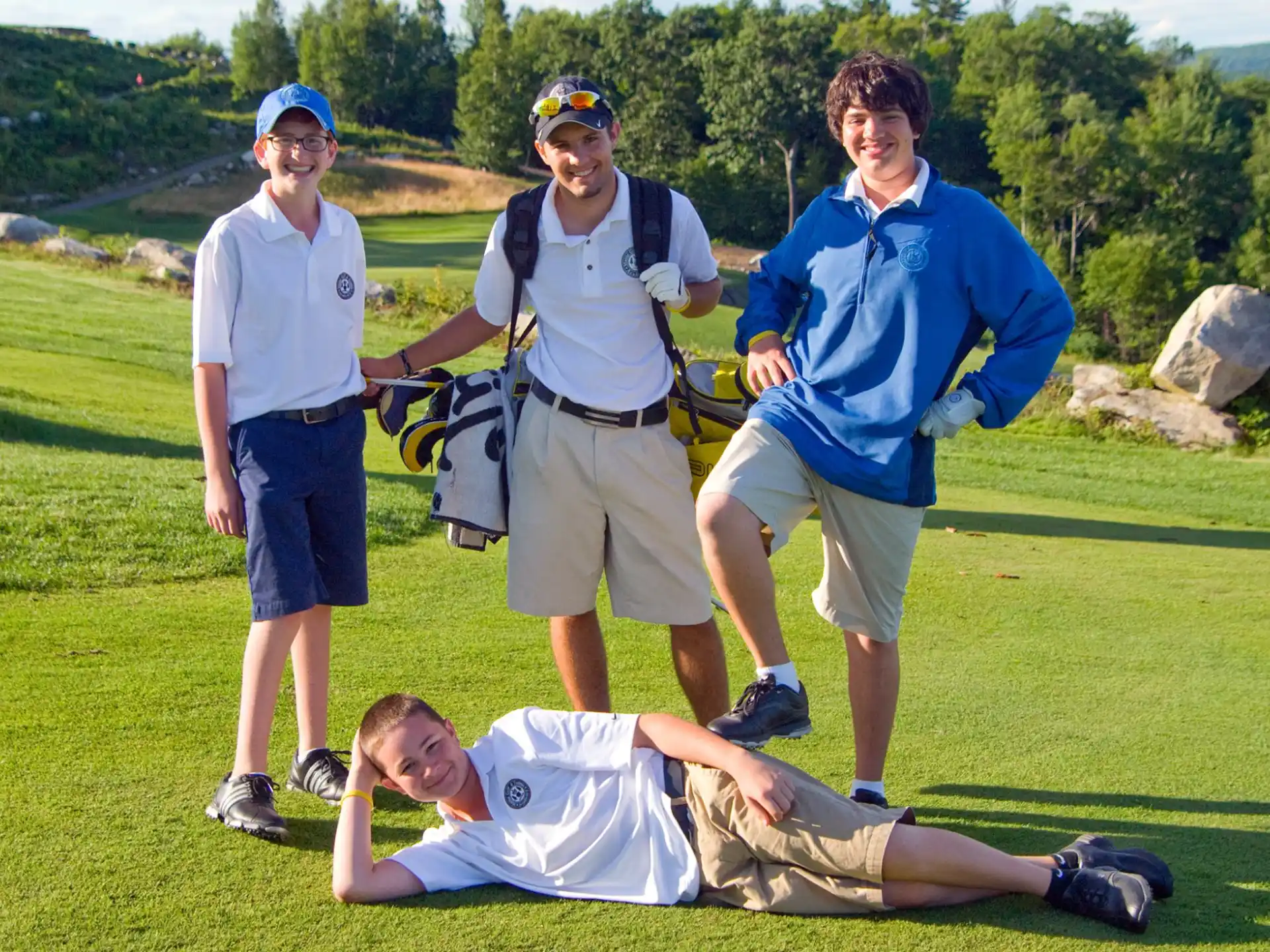 a group of people standing around a person lying on the ground
