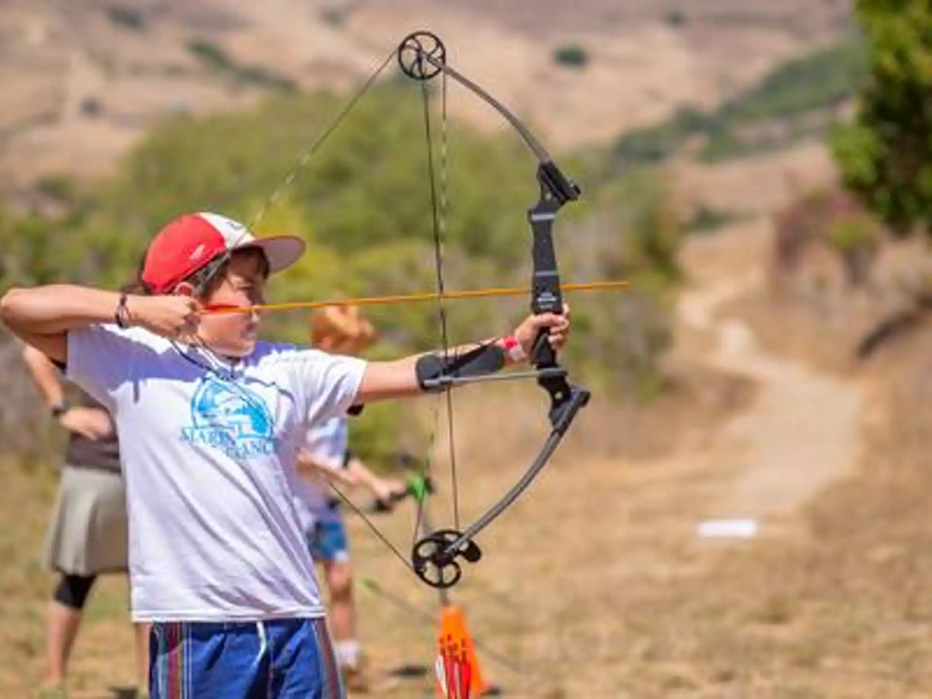 a person shooting a bow and arrow