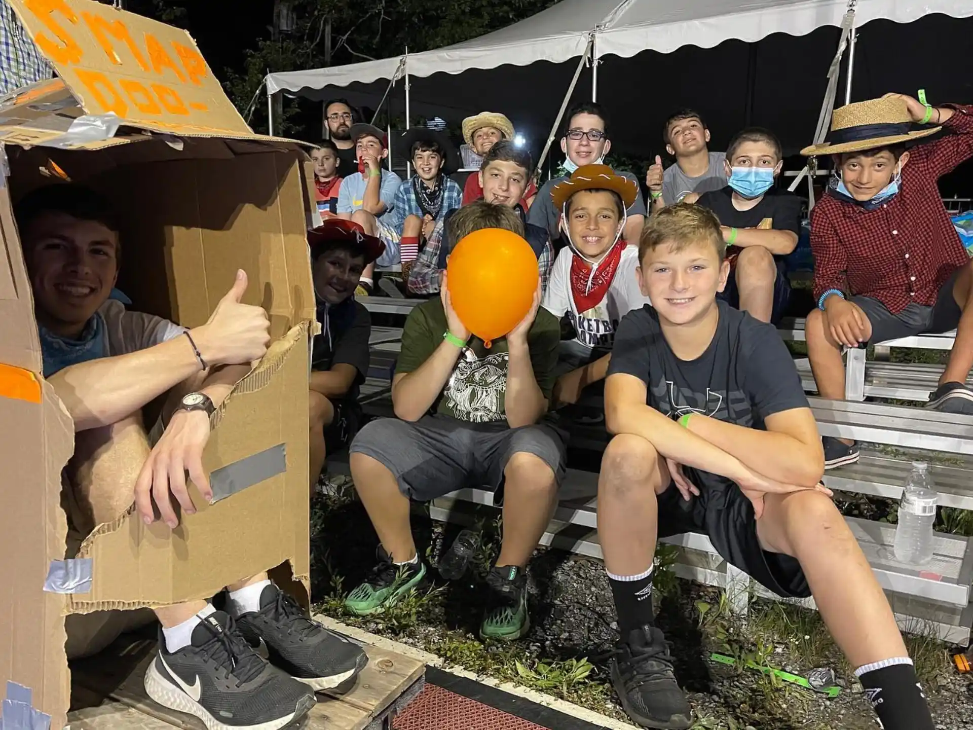 a group of people sitting in a tent