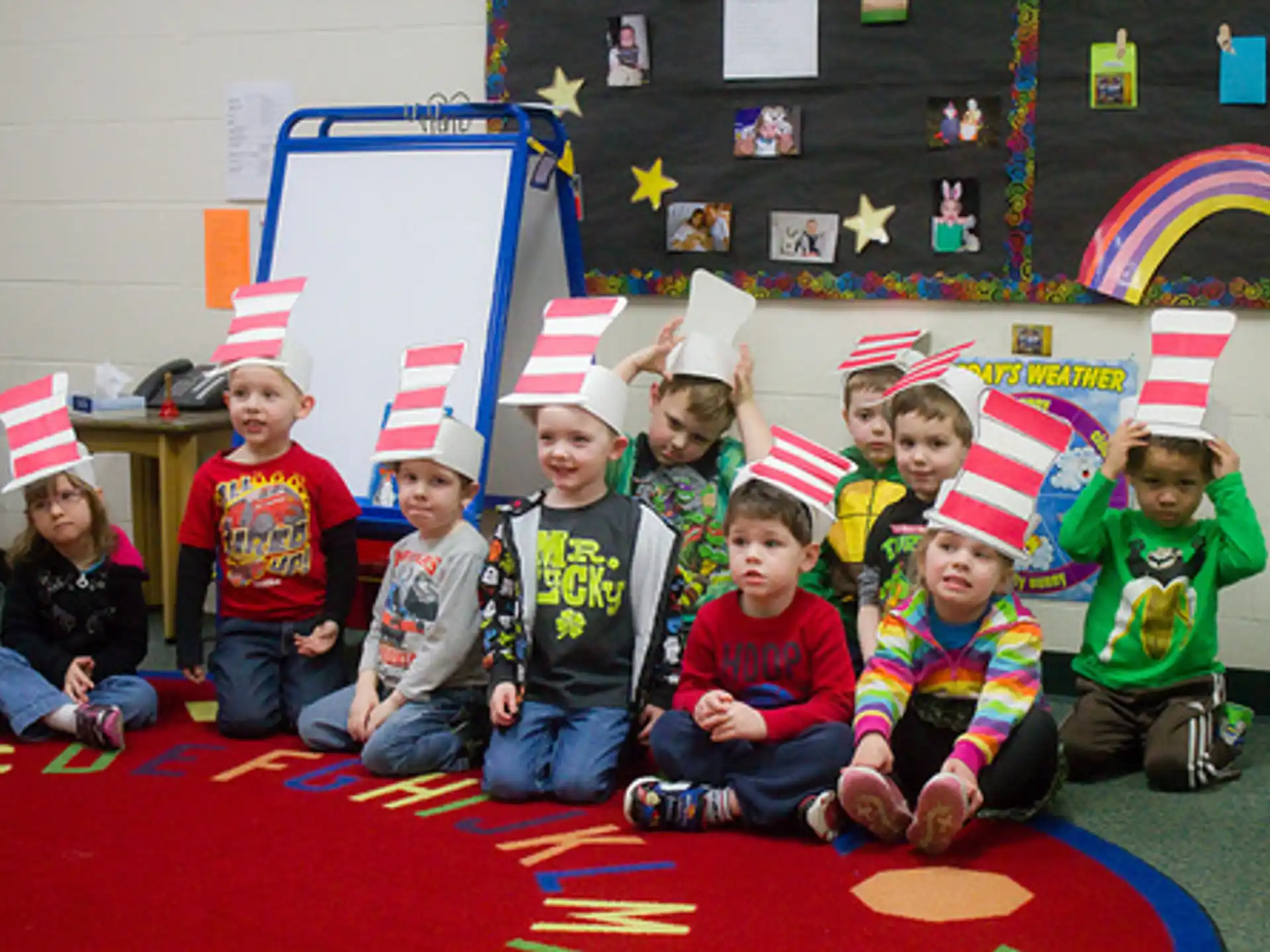 a group of children wearing party hats