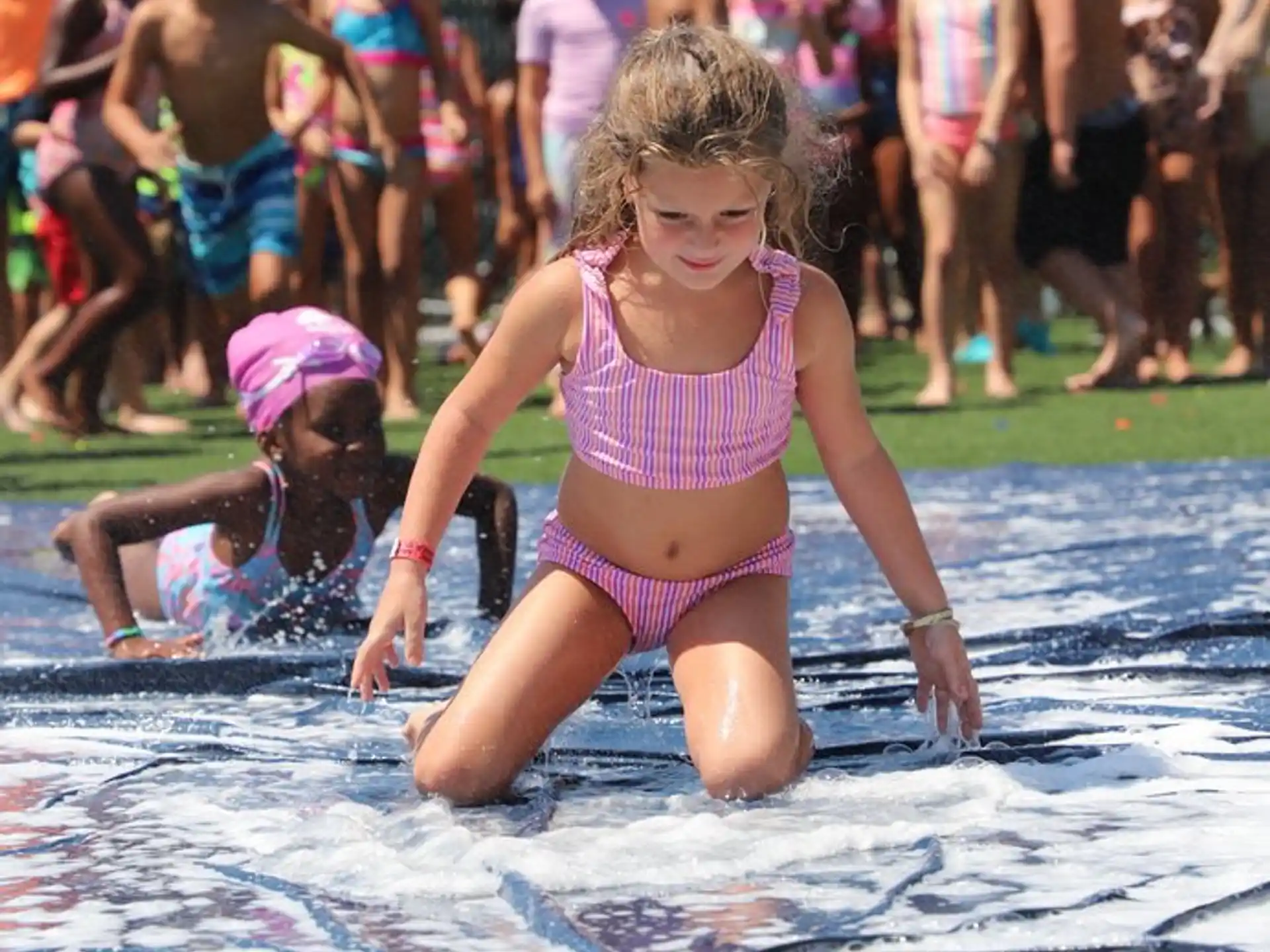 a group of children playing in a pool