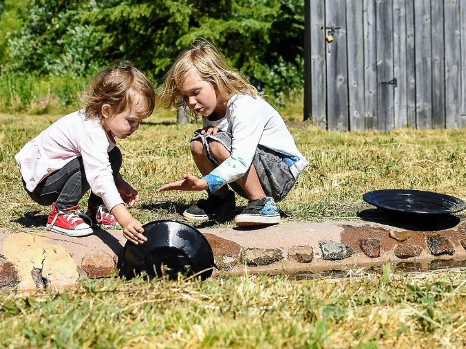 a couple of girls playing with rocks