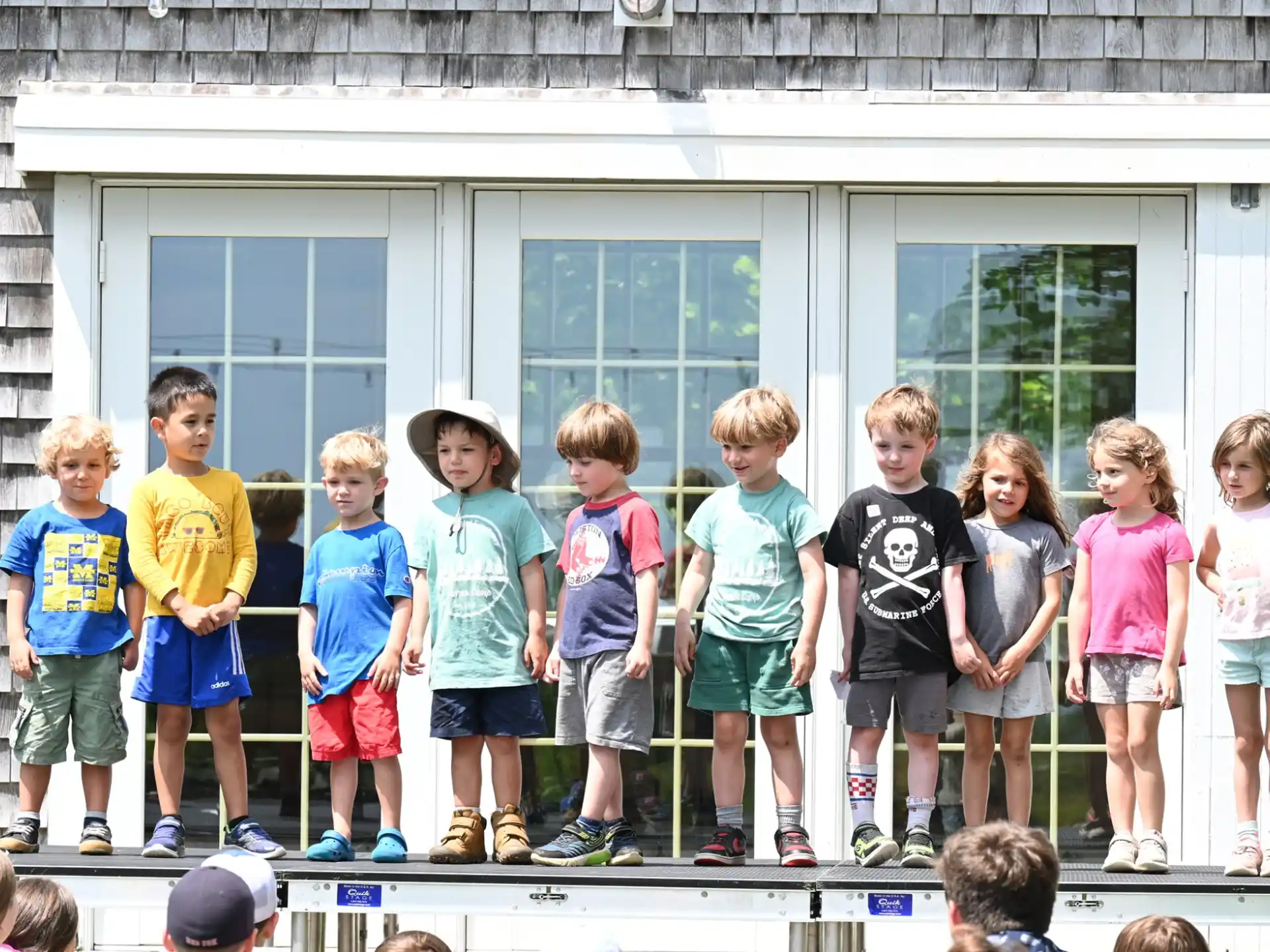 a group of children standing outside a building