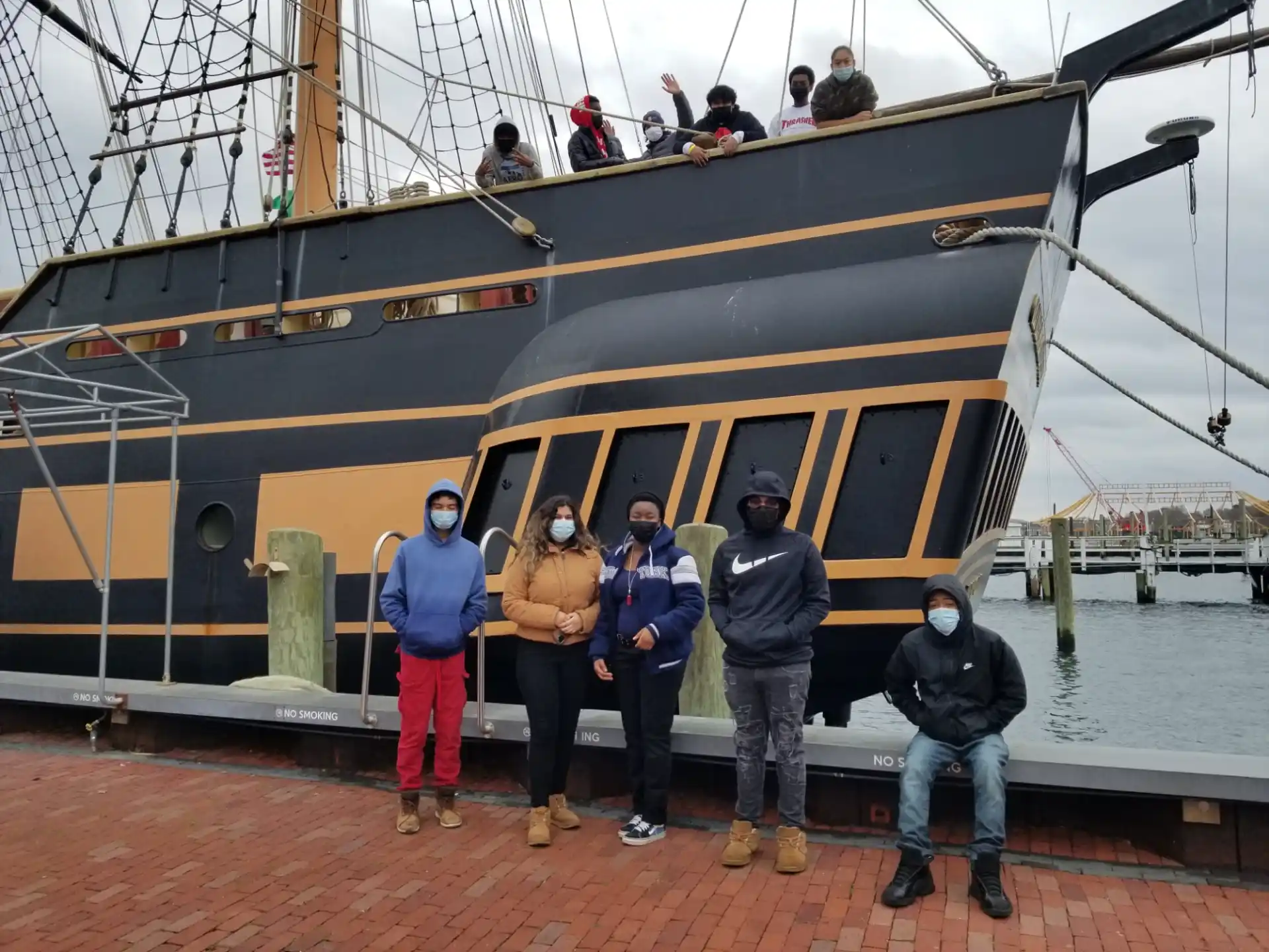 a group of people standing on a boat