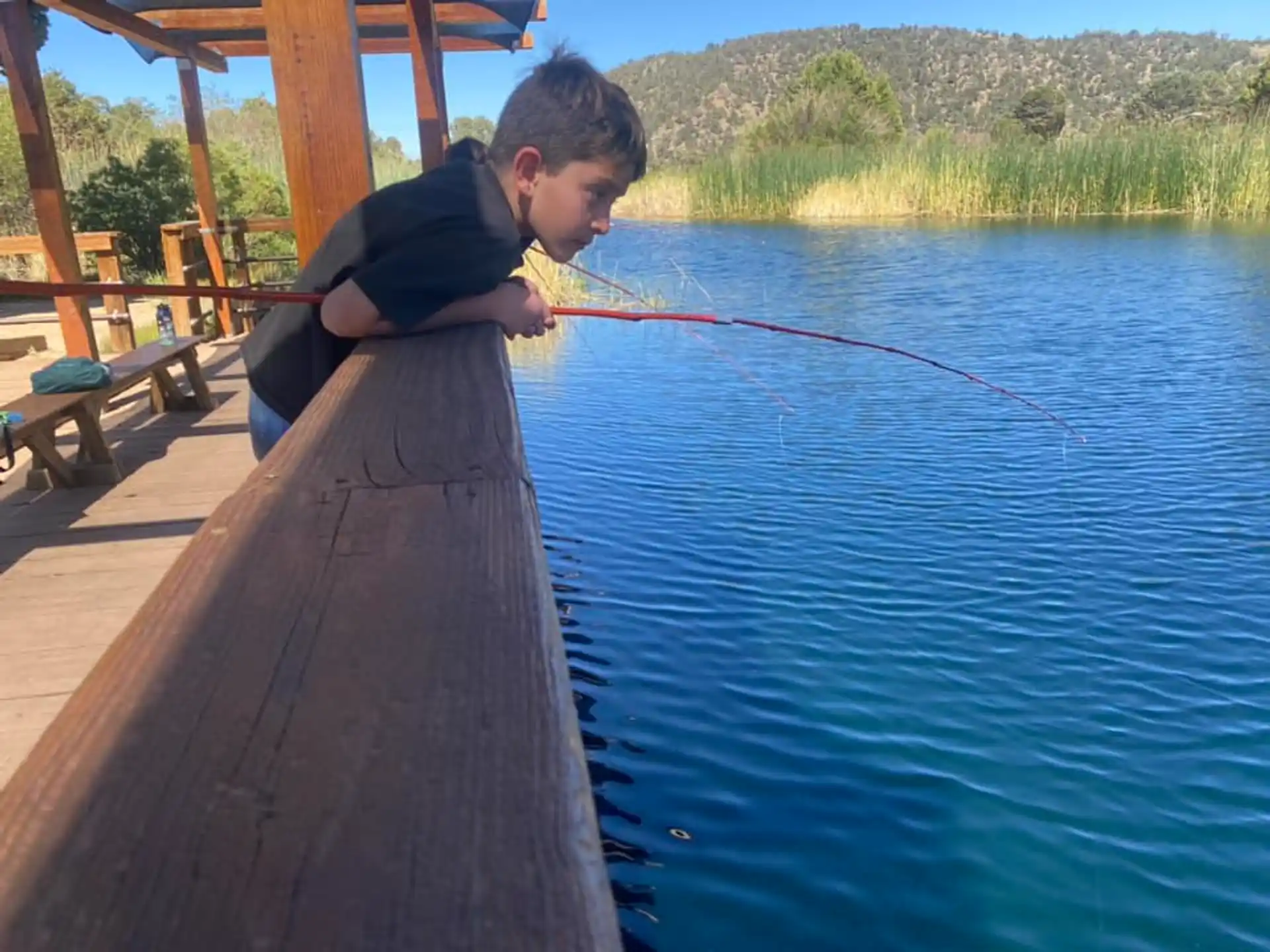 a boy fishing on a dock