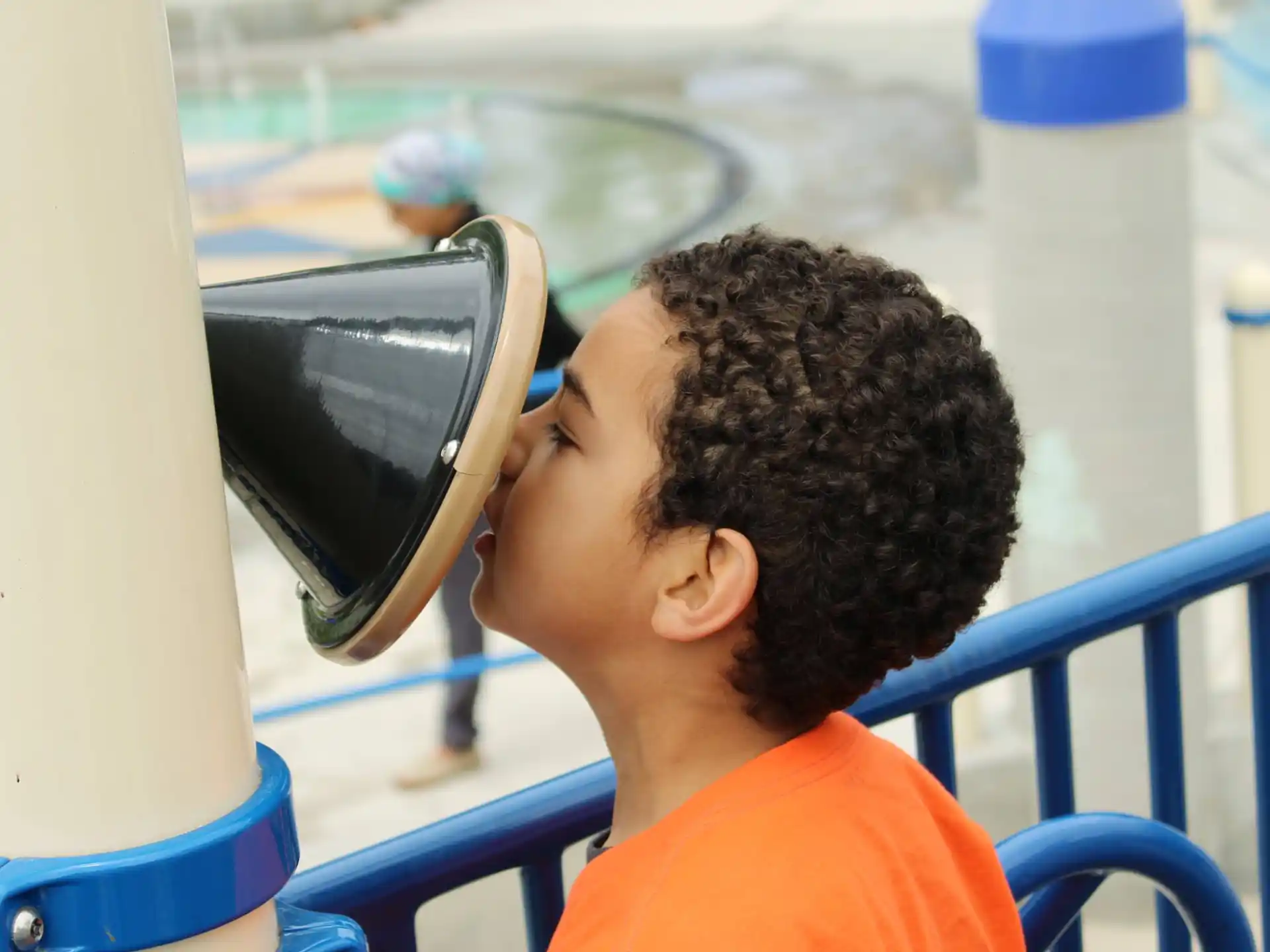 a young boy looking through a microscope