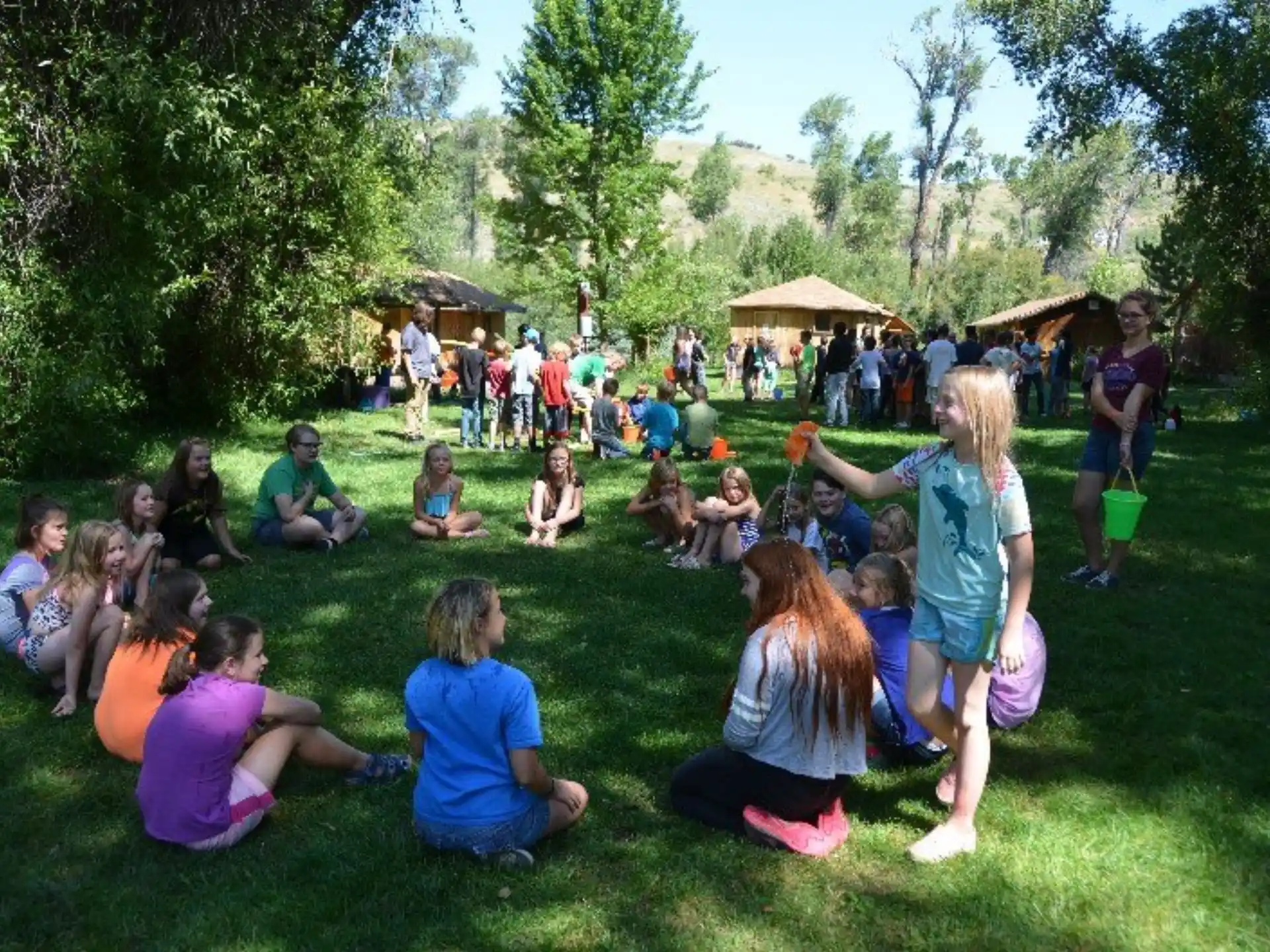 a group of people sitting on the grass