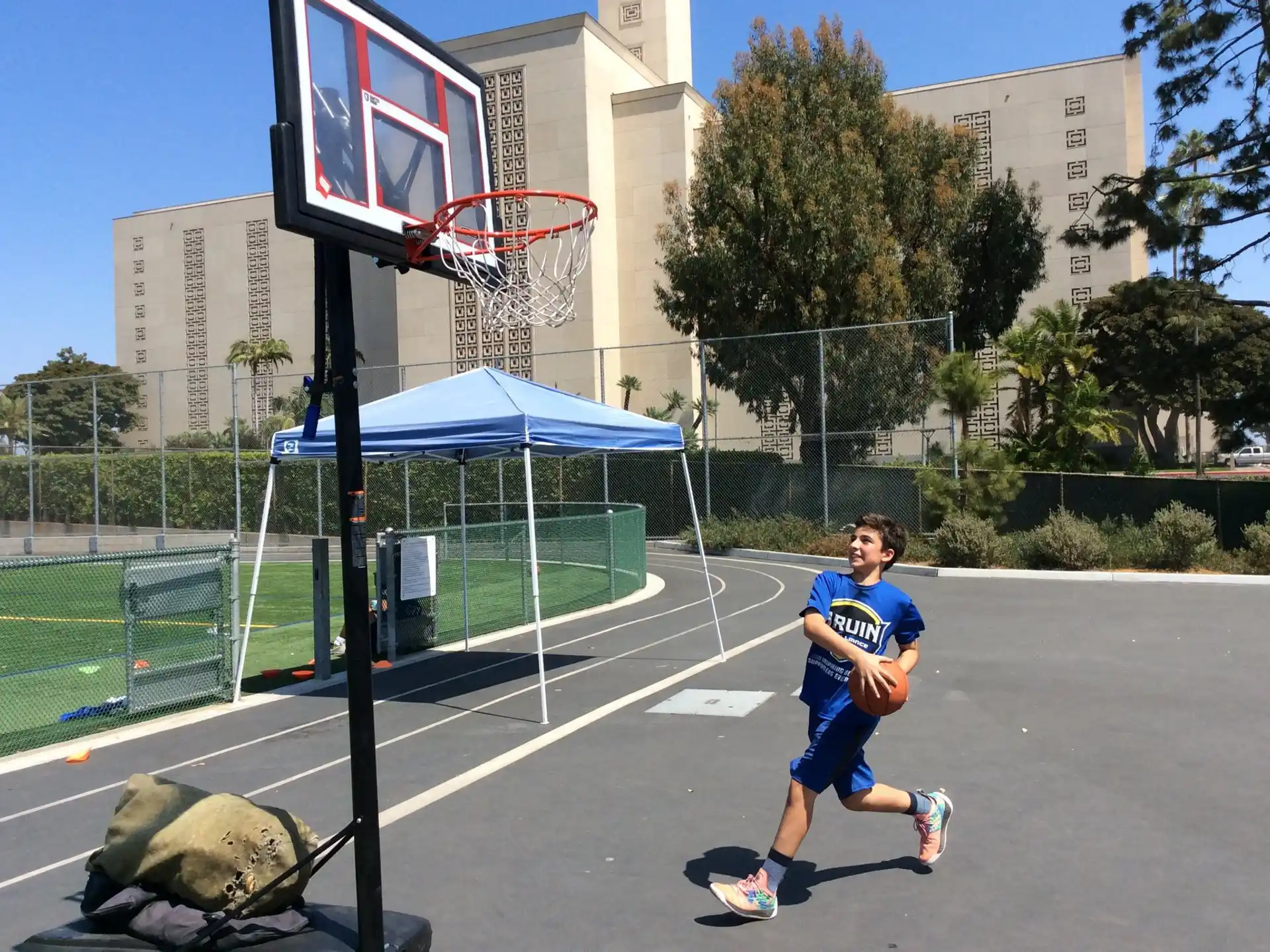 a boy running on a basketball court