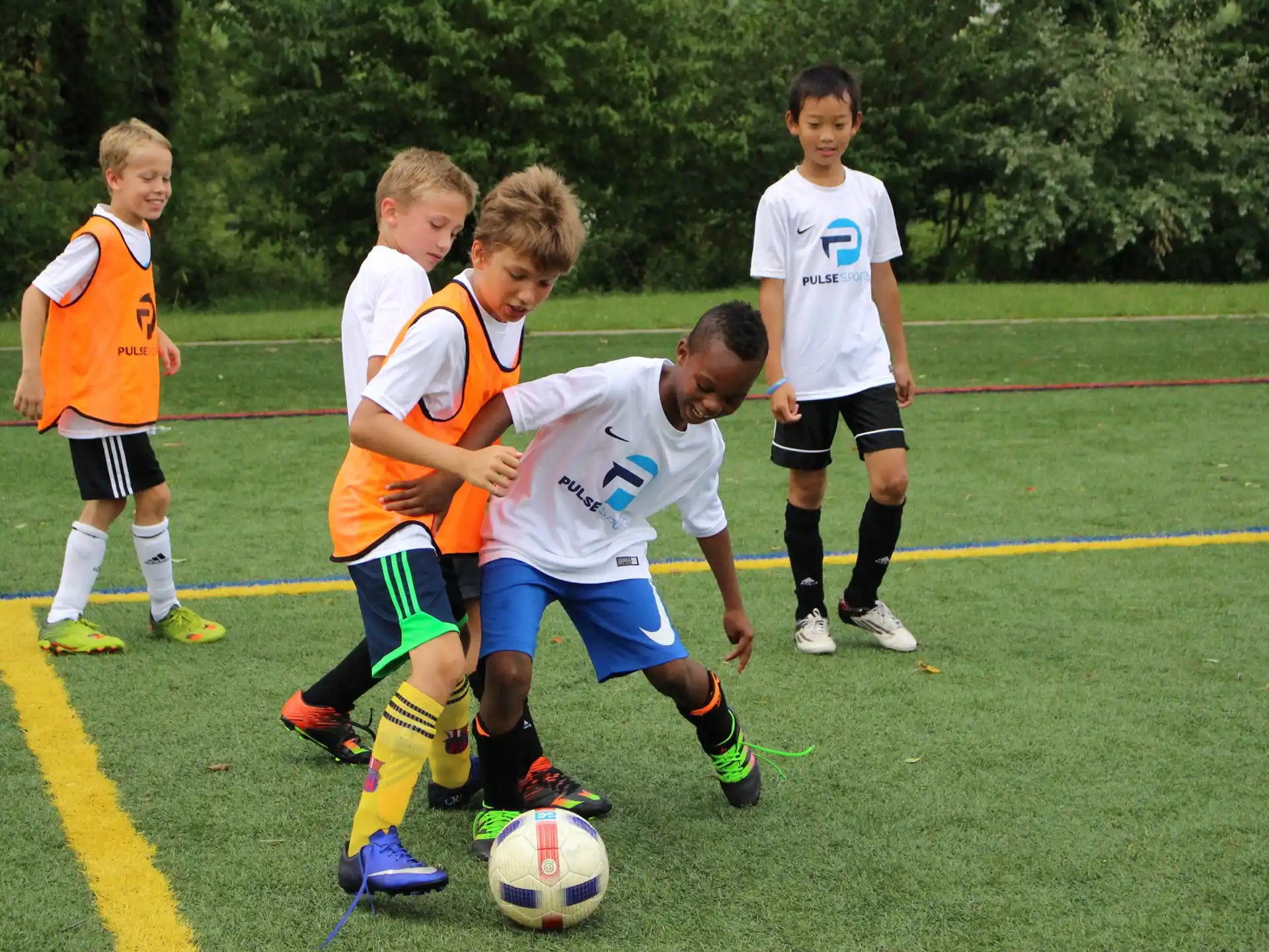 a group of kids playing football