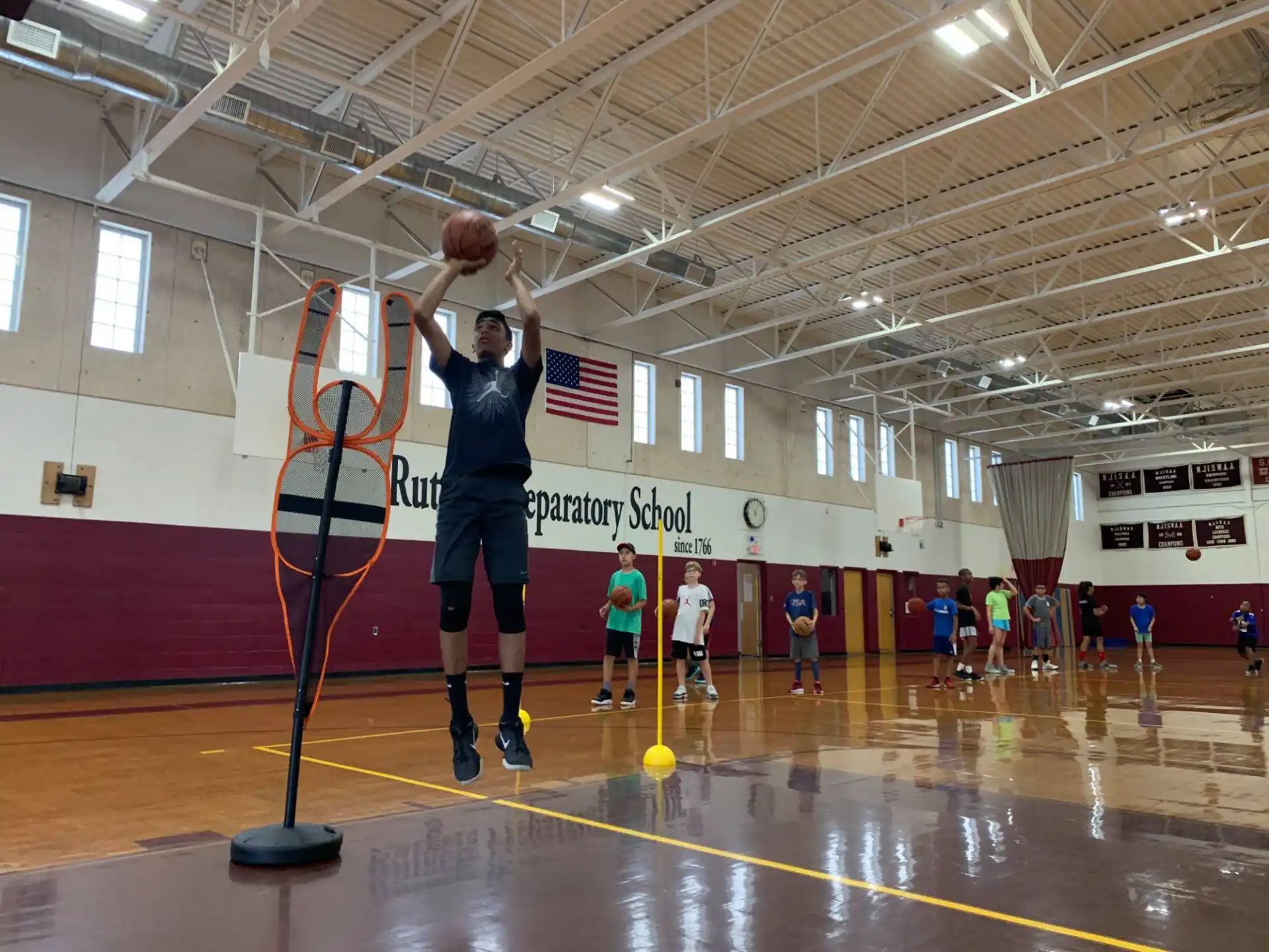 a person holding a basketball in a gym