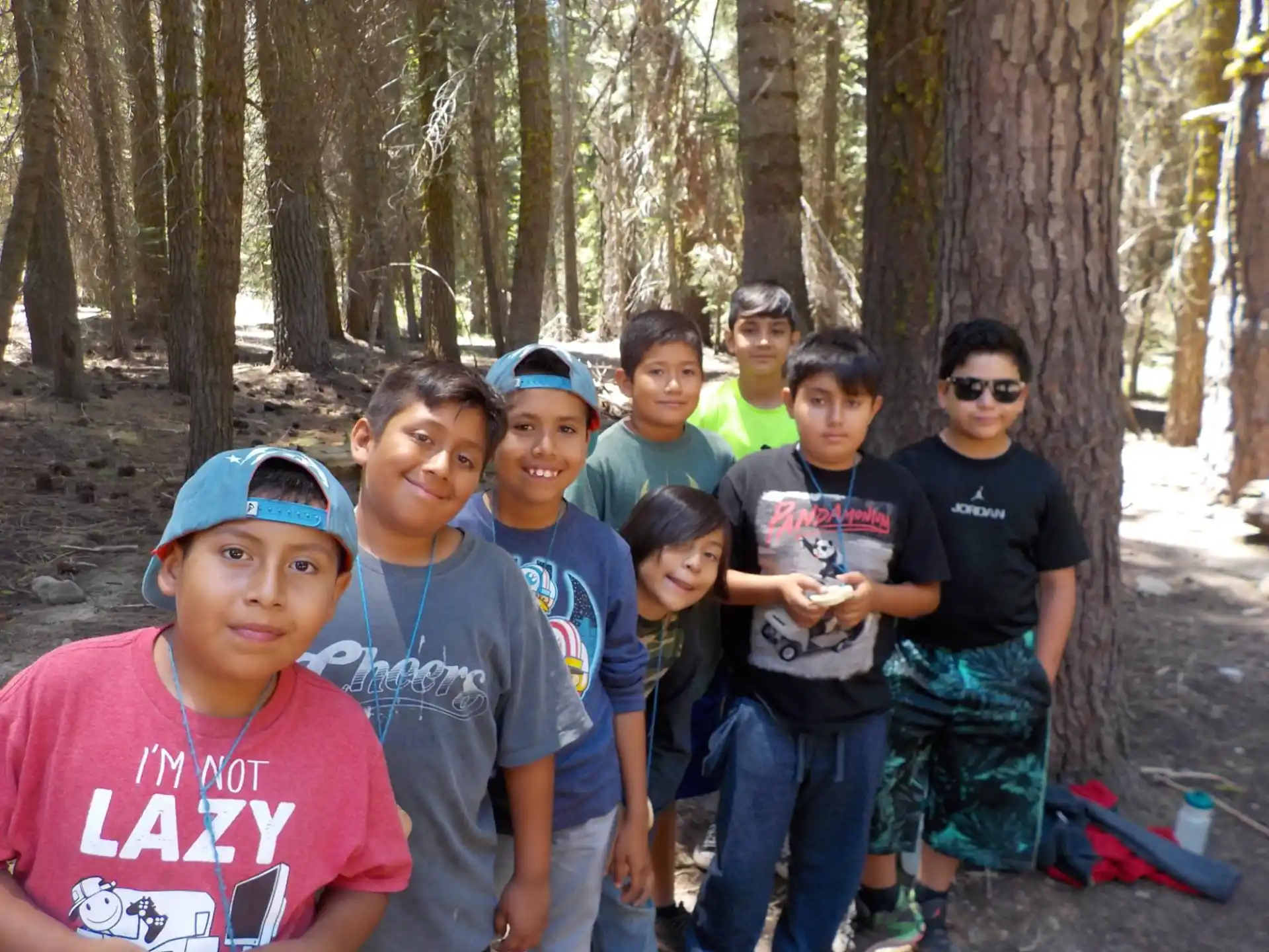 a group of people posing for a photo in the woods
