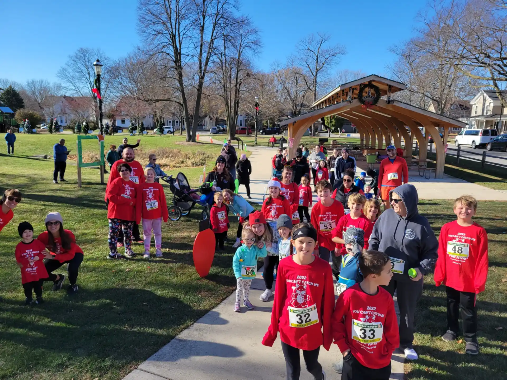 a group of children in red shirts