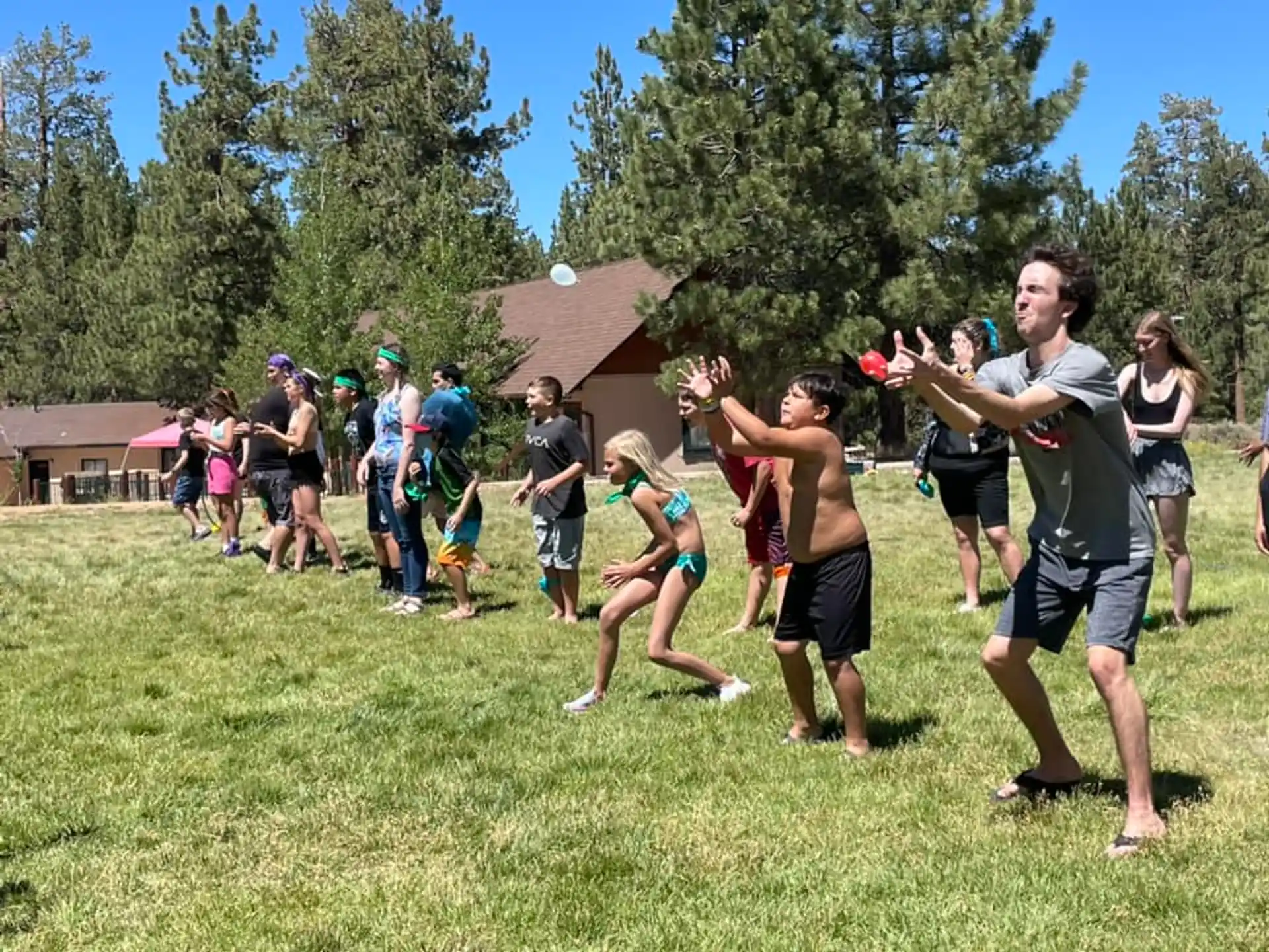 a group of people playing frisbee in a field