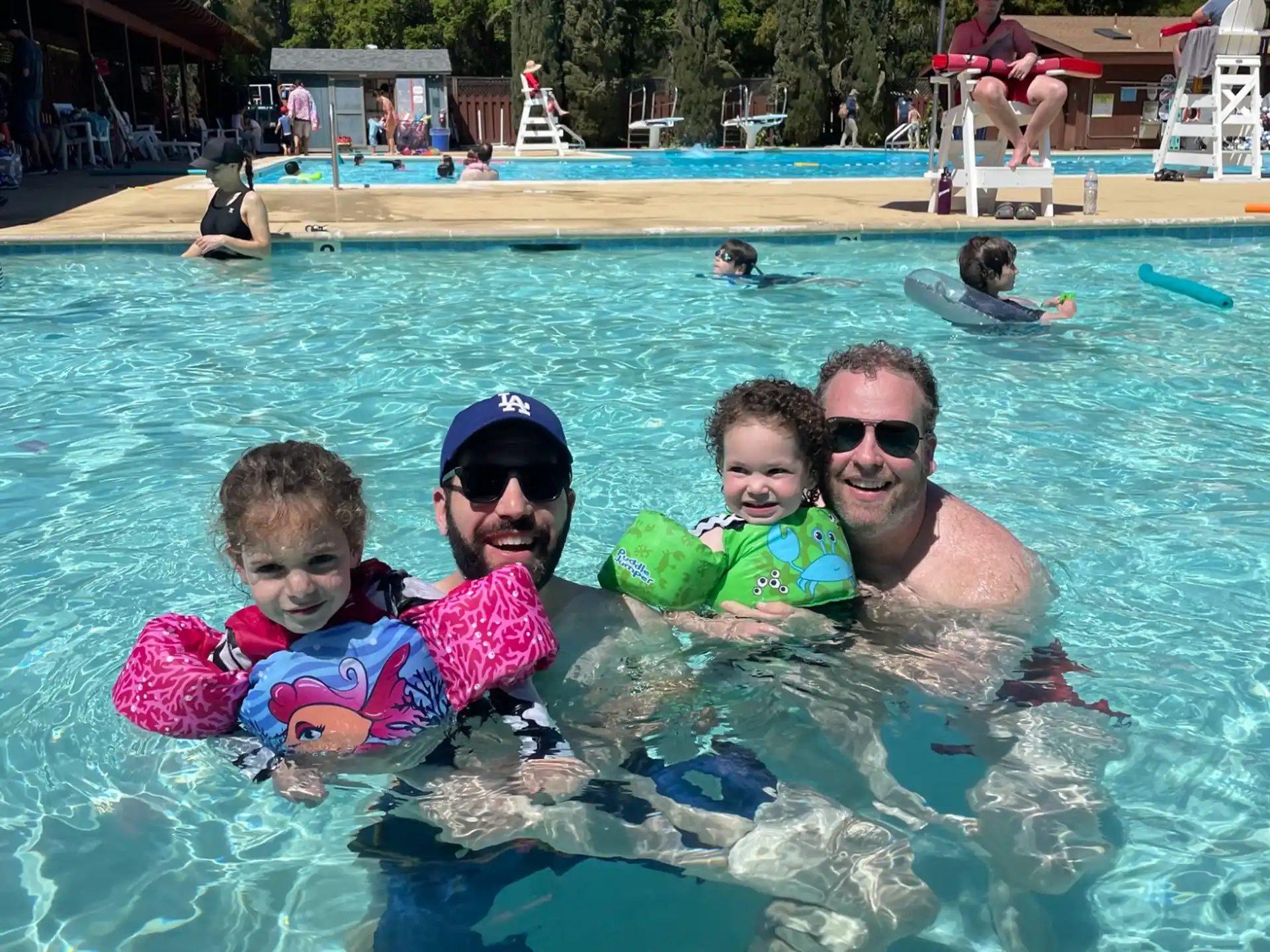 a person and two children in a pool