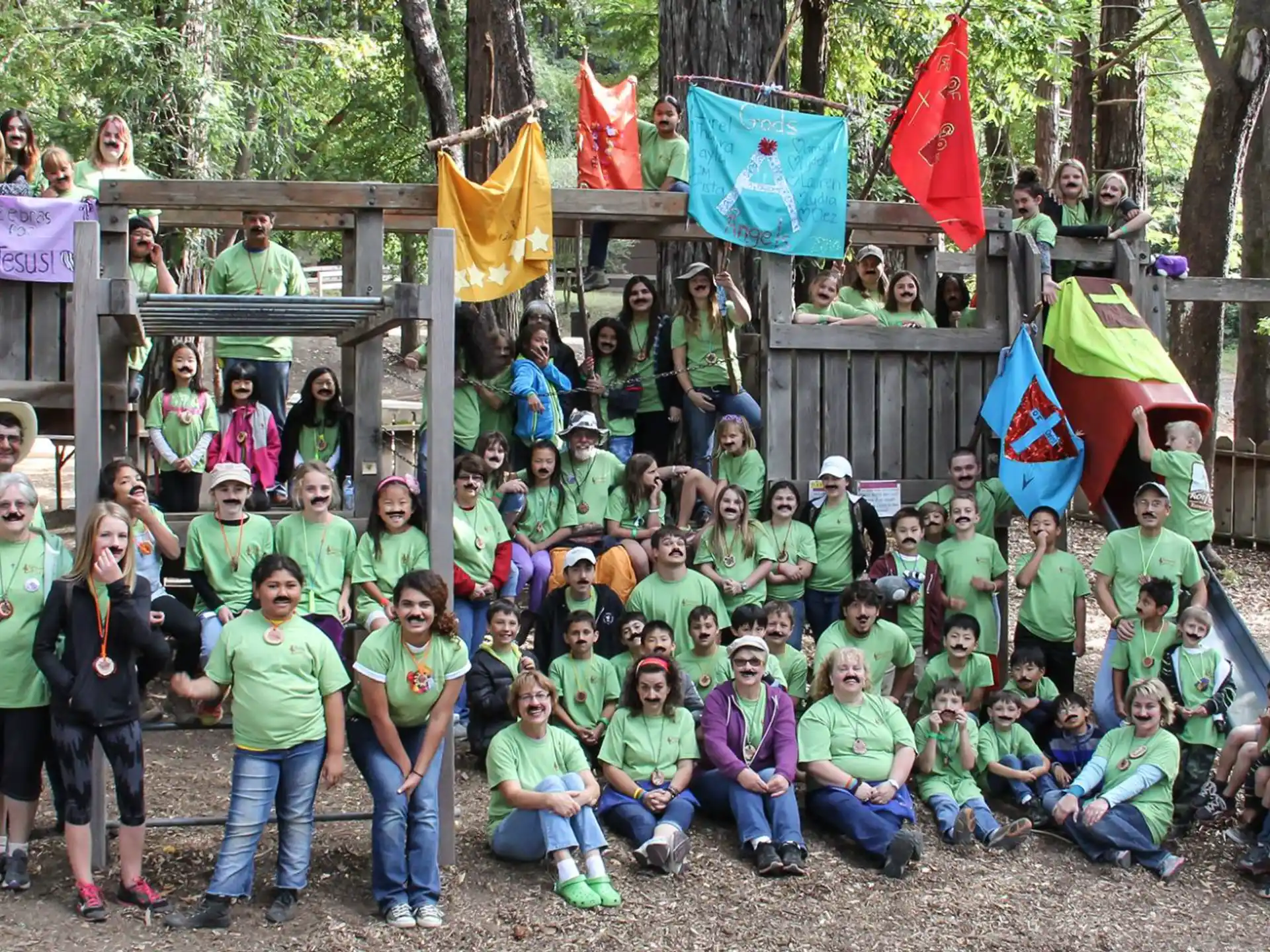 a group of people posing for a photo with flags