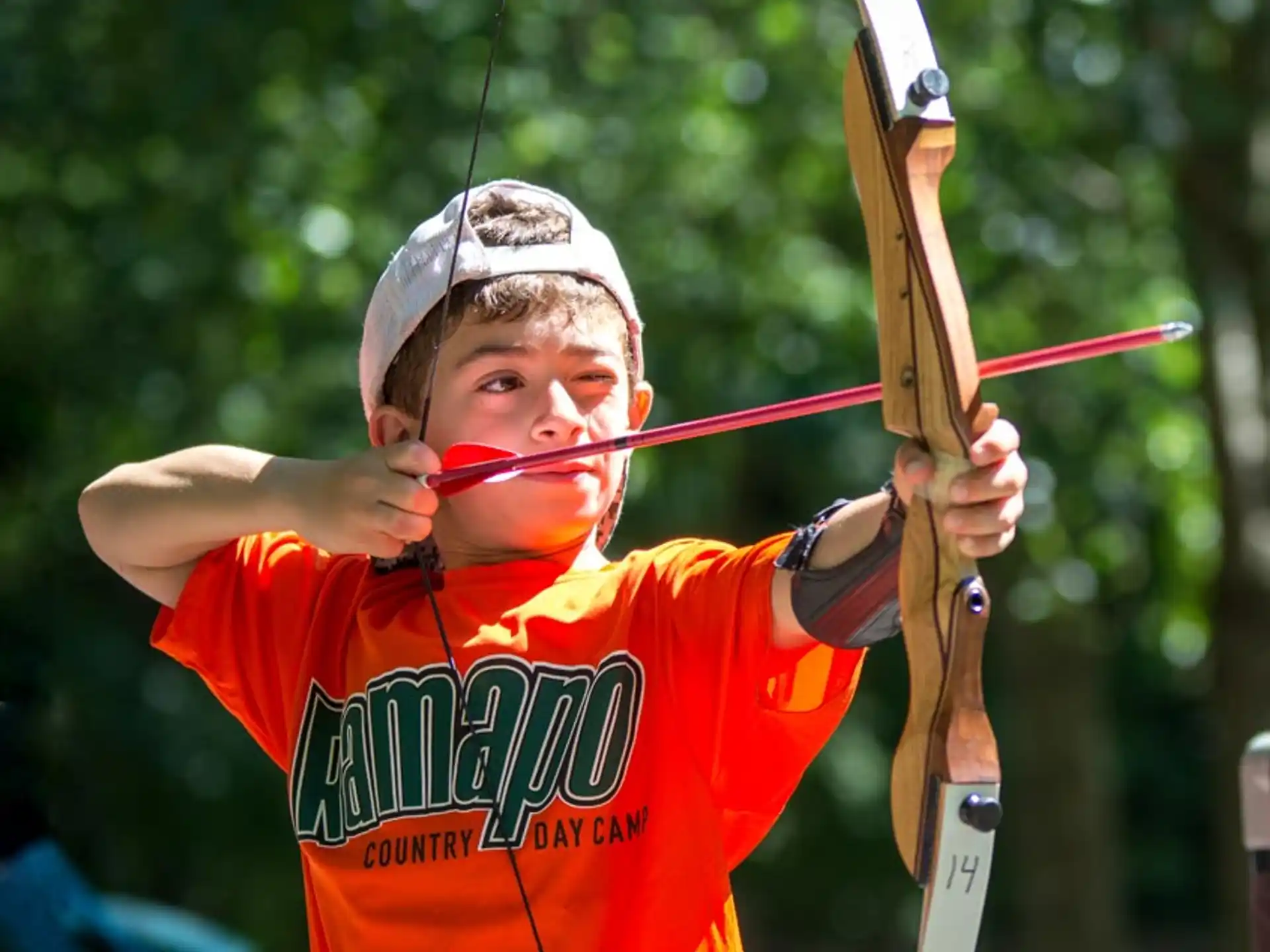 a boy holding a bow and arrow