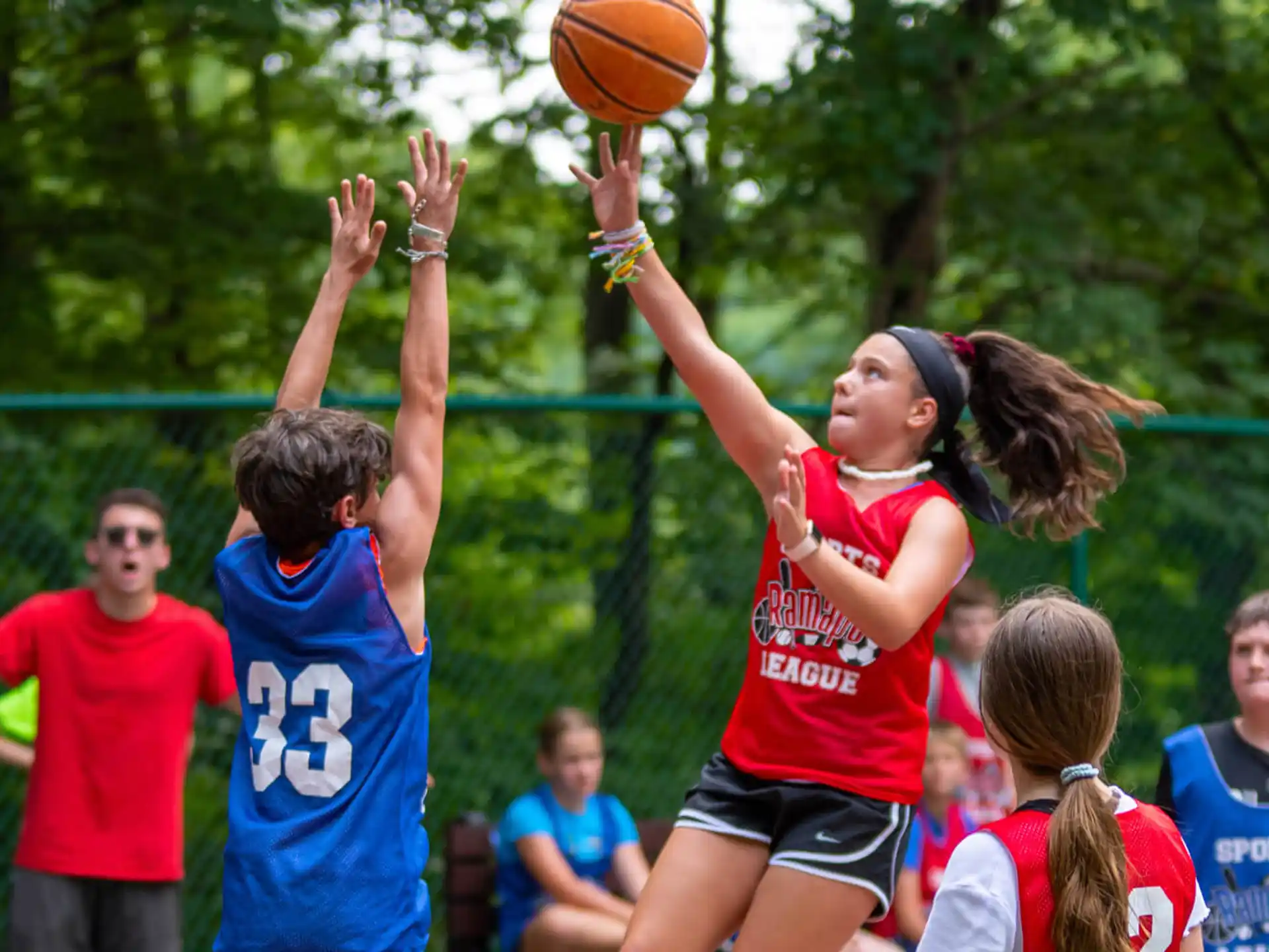 a group of kids playing basketball