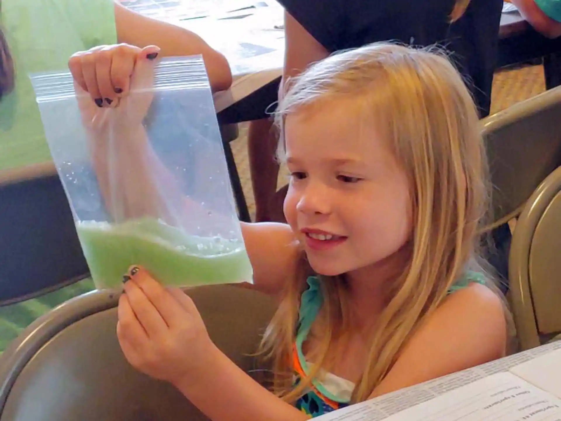 a girl drinking from a glass