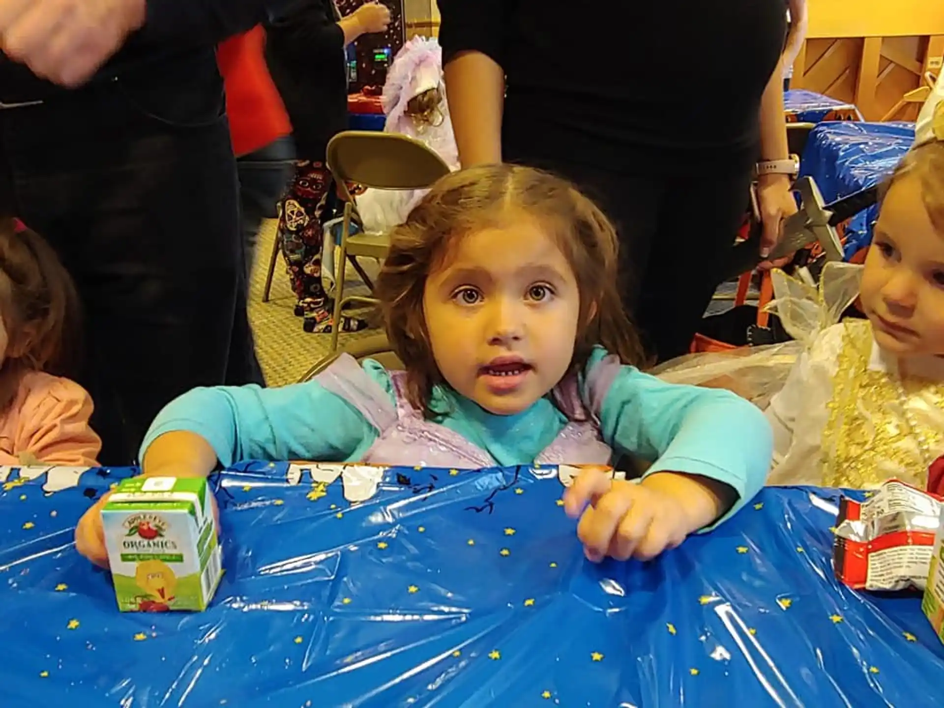 a little girl sitting on the floor