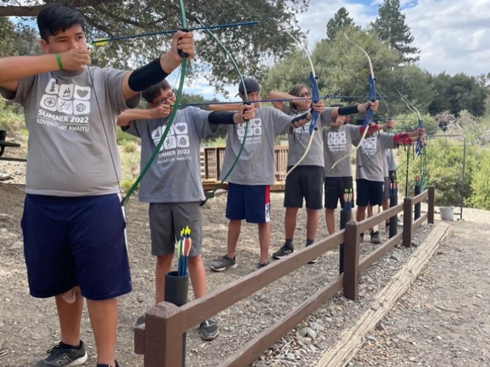 a group of people holding bows and arrows