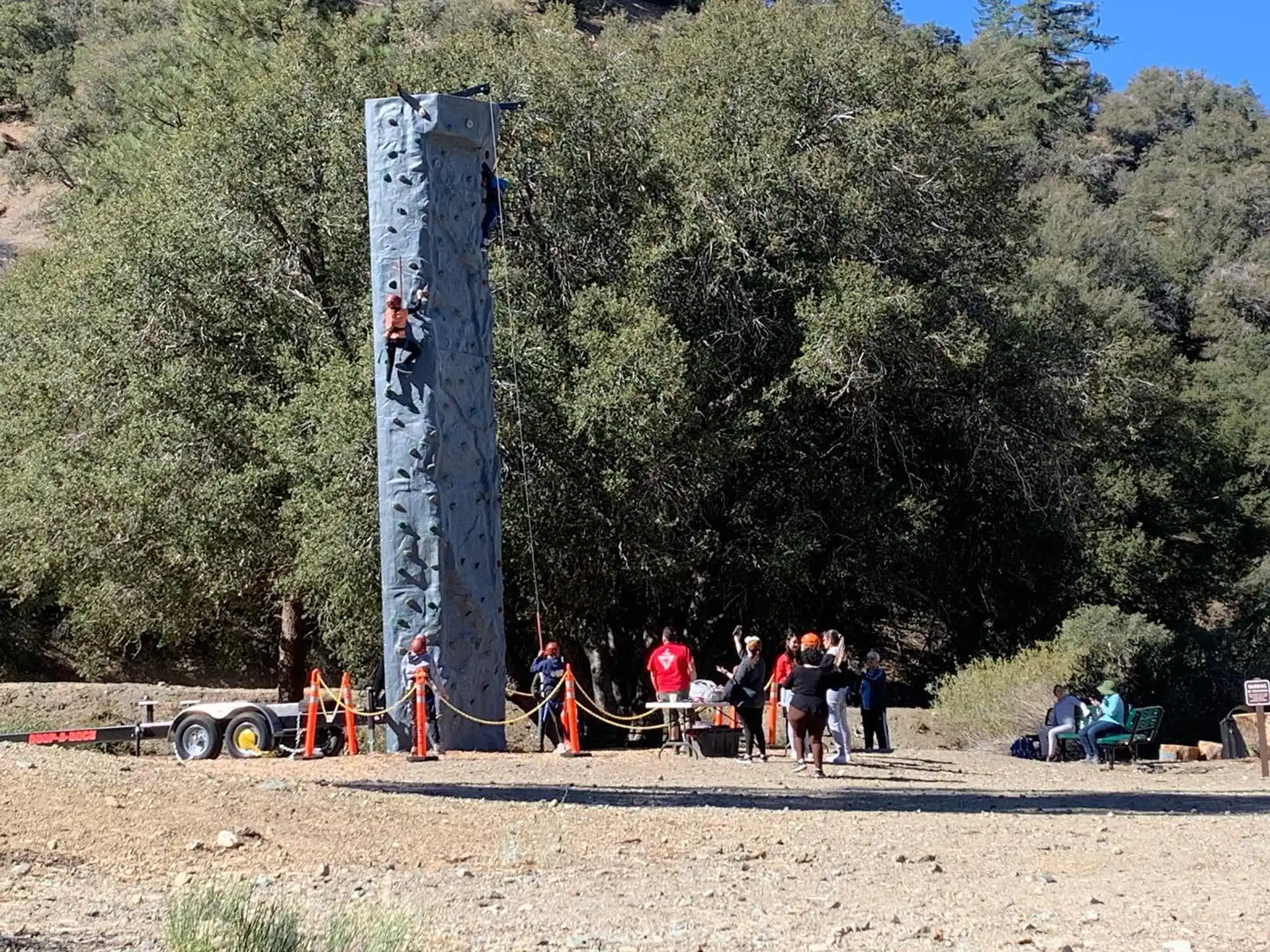 a group of people standing next to a large statue