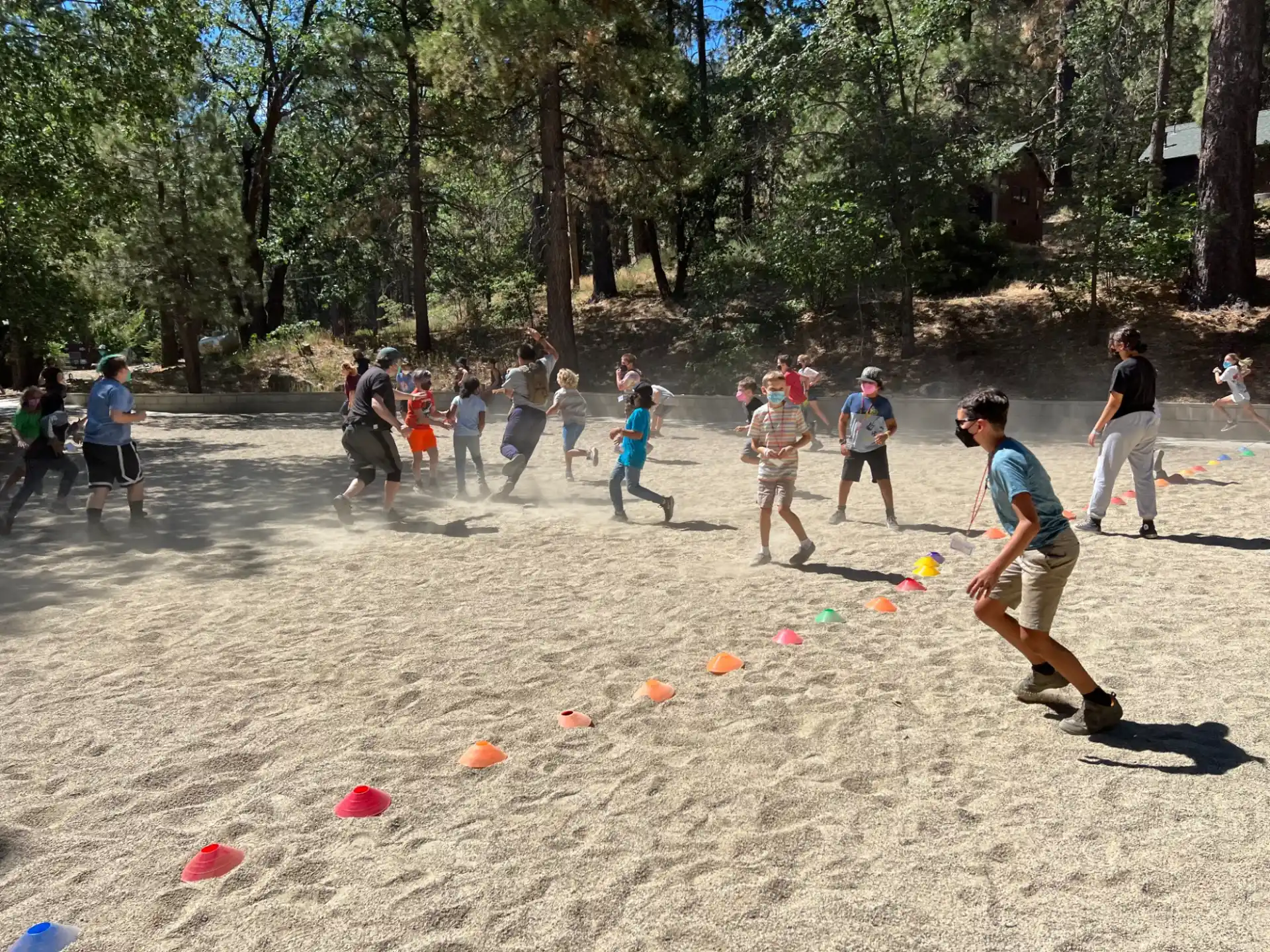 a group of people playing frisbee in a park