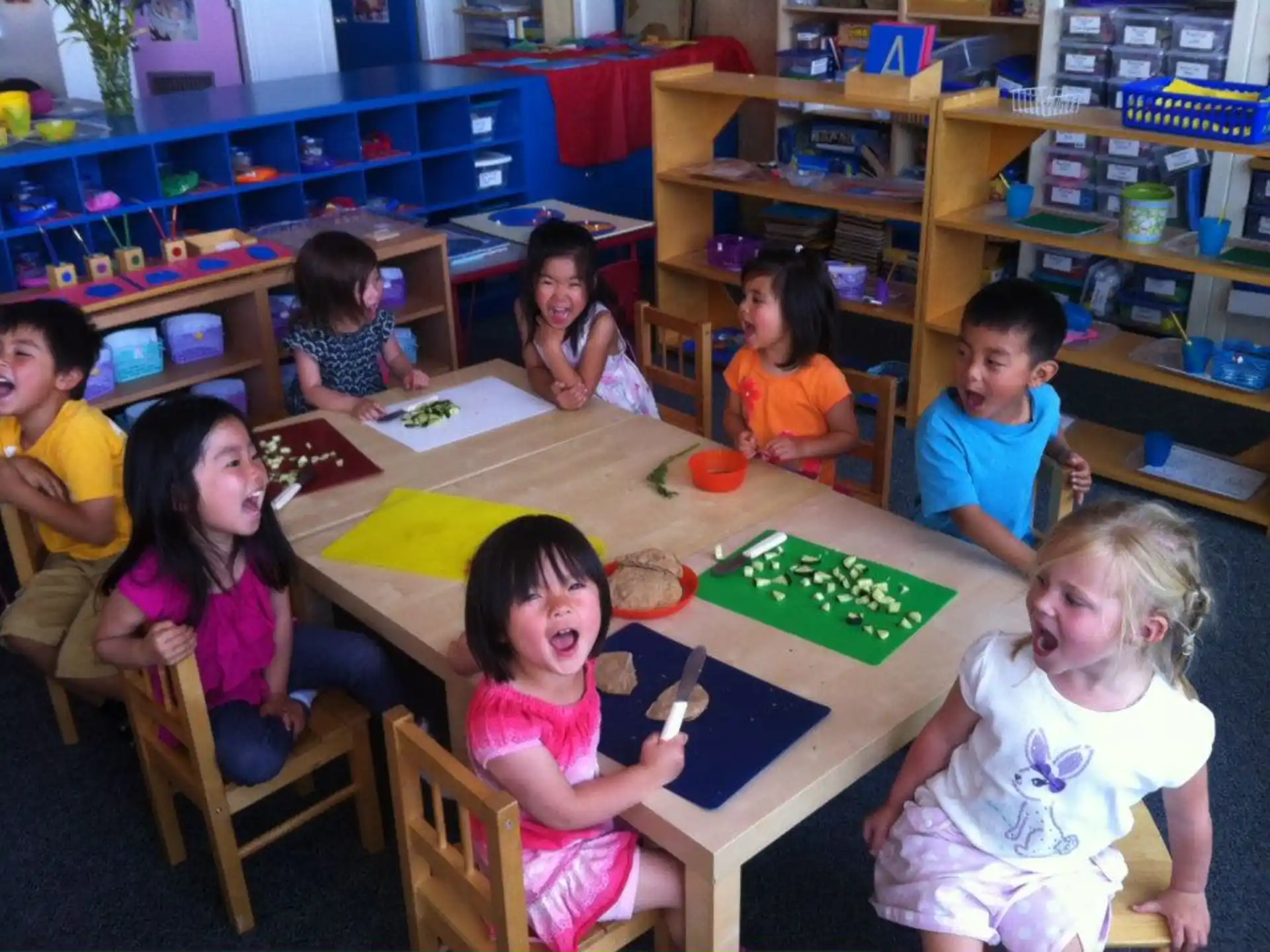 a group of children sitting at a table