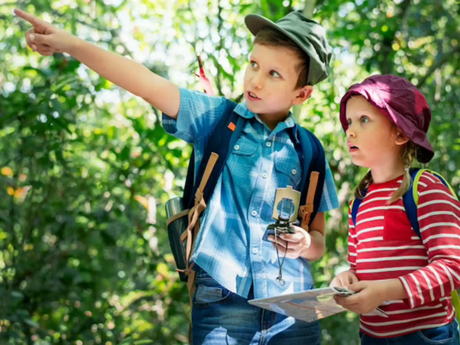 a couple of children holding objects posing for the camera
