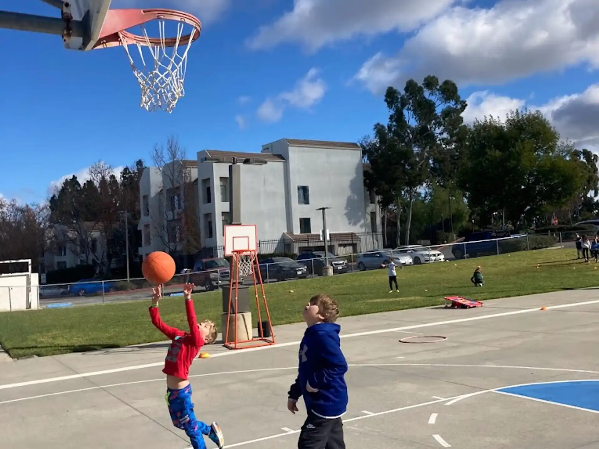 a couple of kids playing basketball