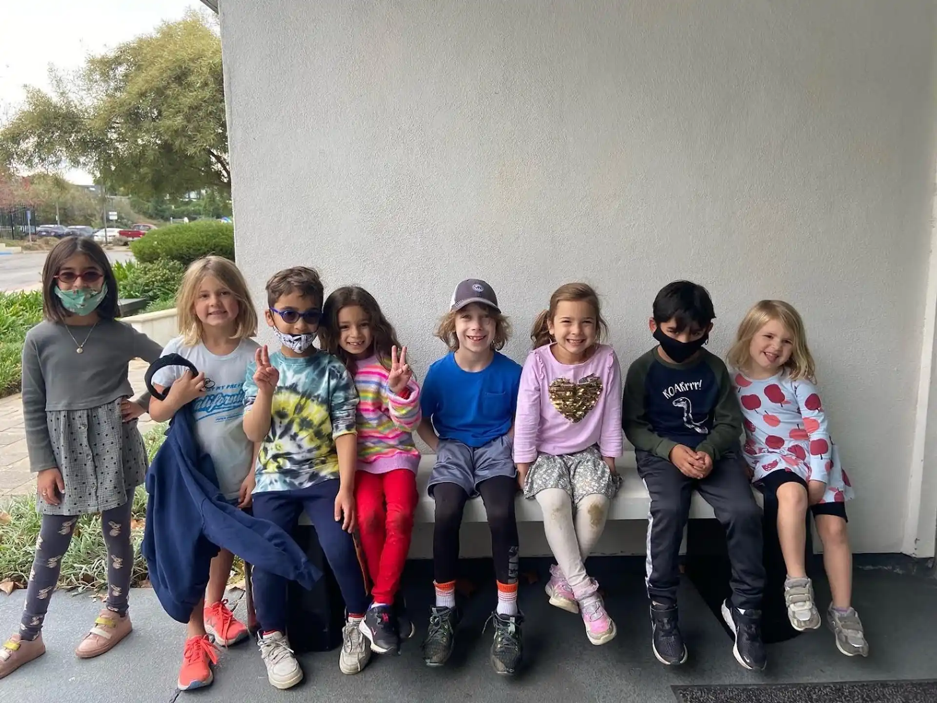 a group of children sitting on a bench