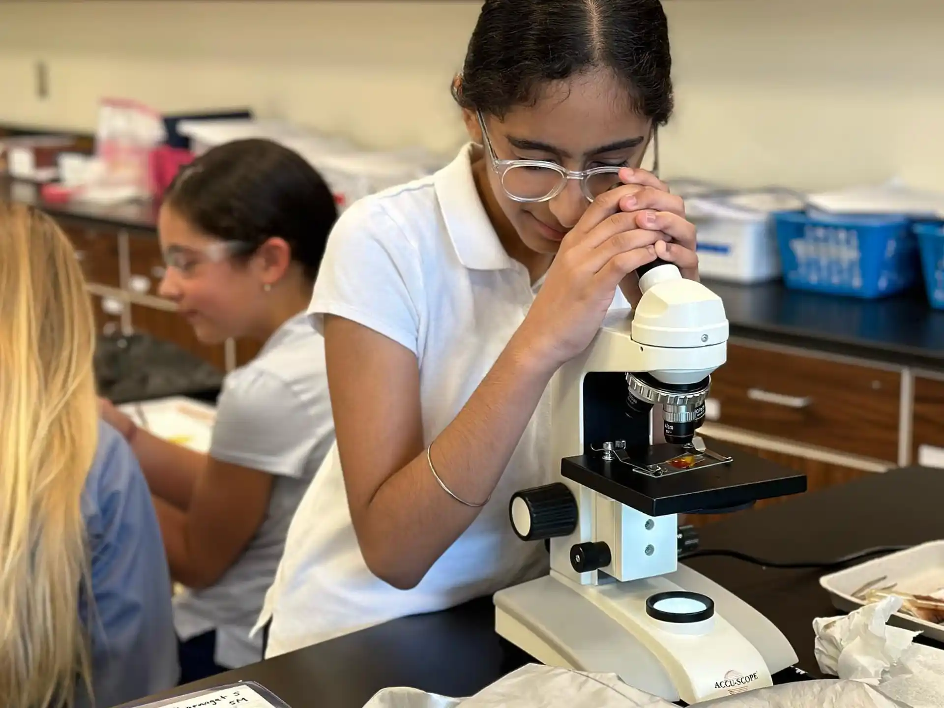 a group of people looking at a microscope
