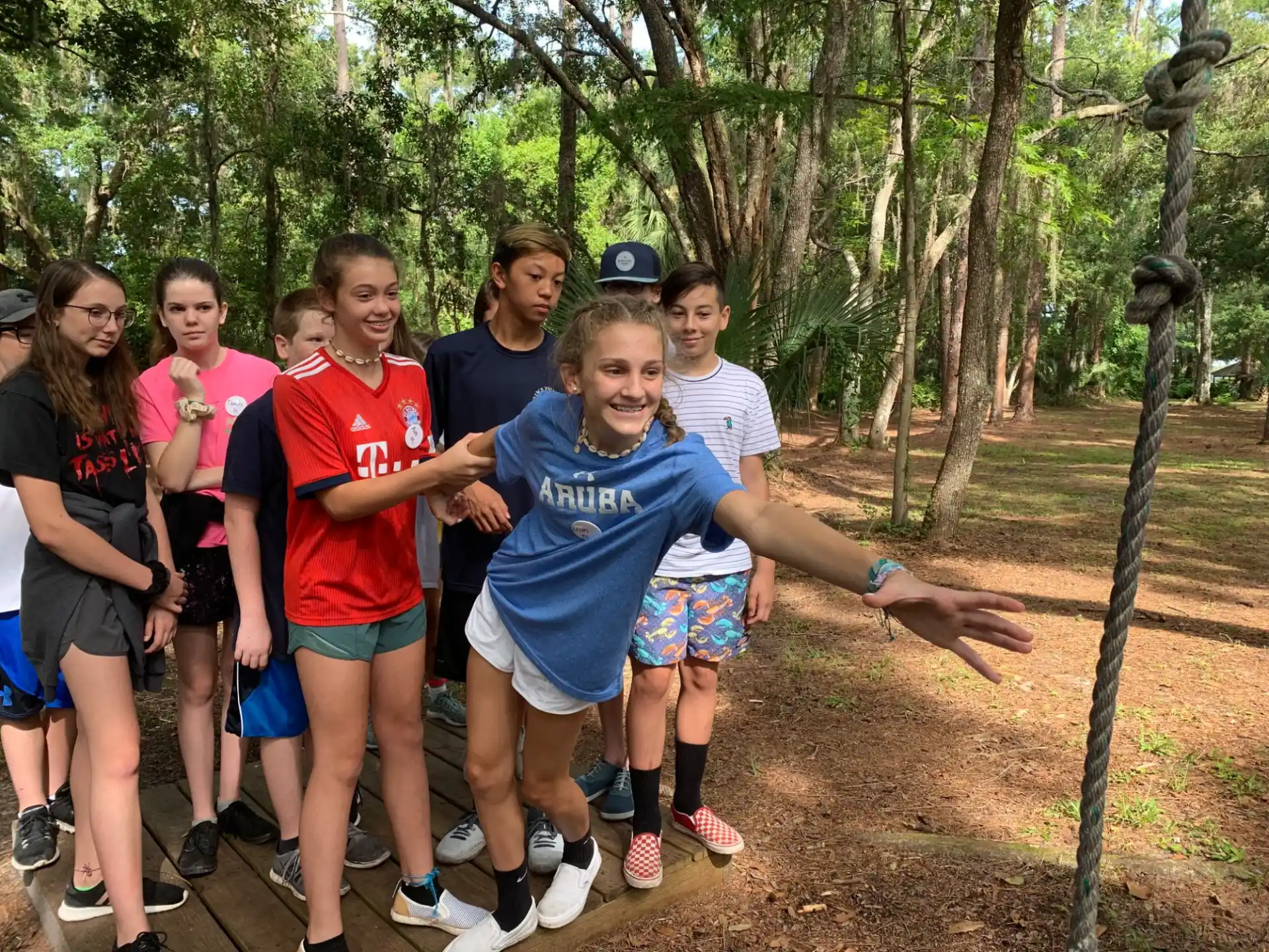 a group of people posing for a photo in the woods