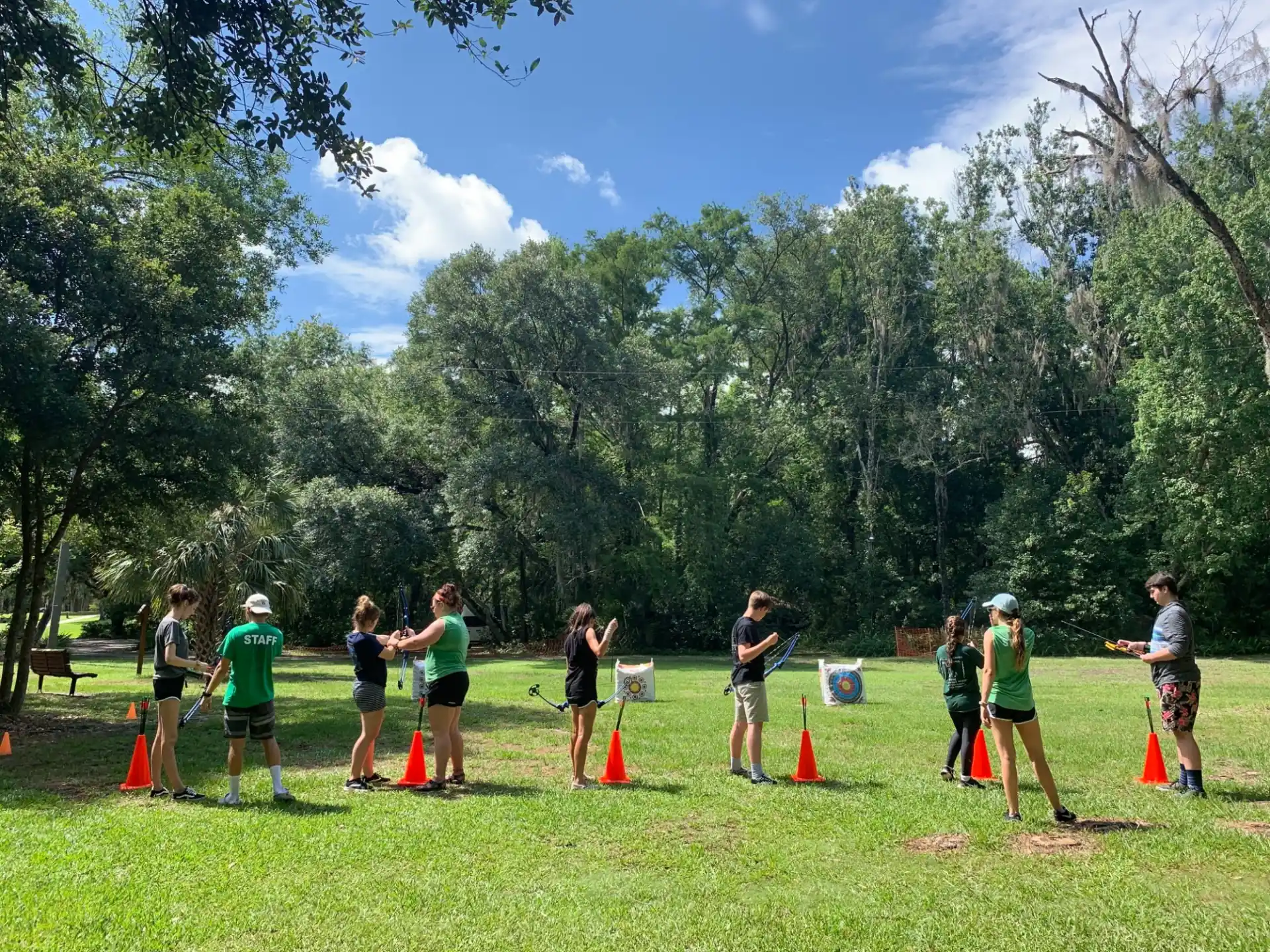 a group of people standing around some cones