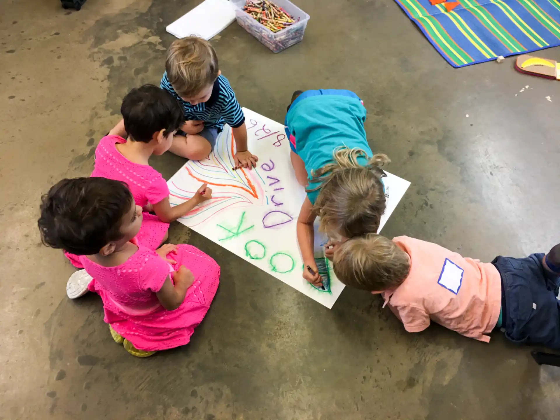 a group of children playing with a paper